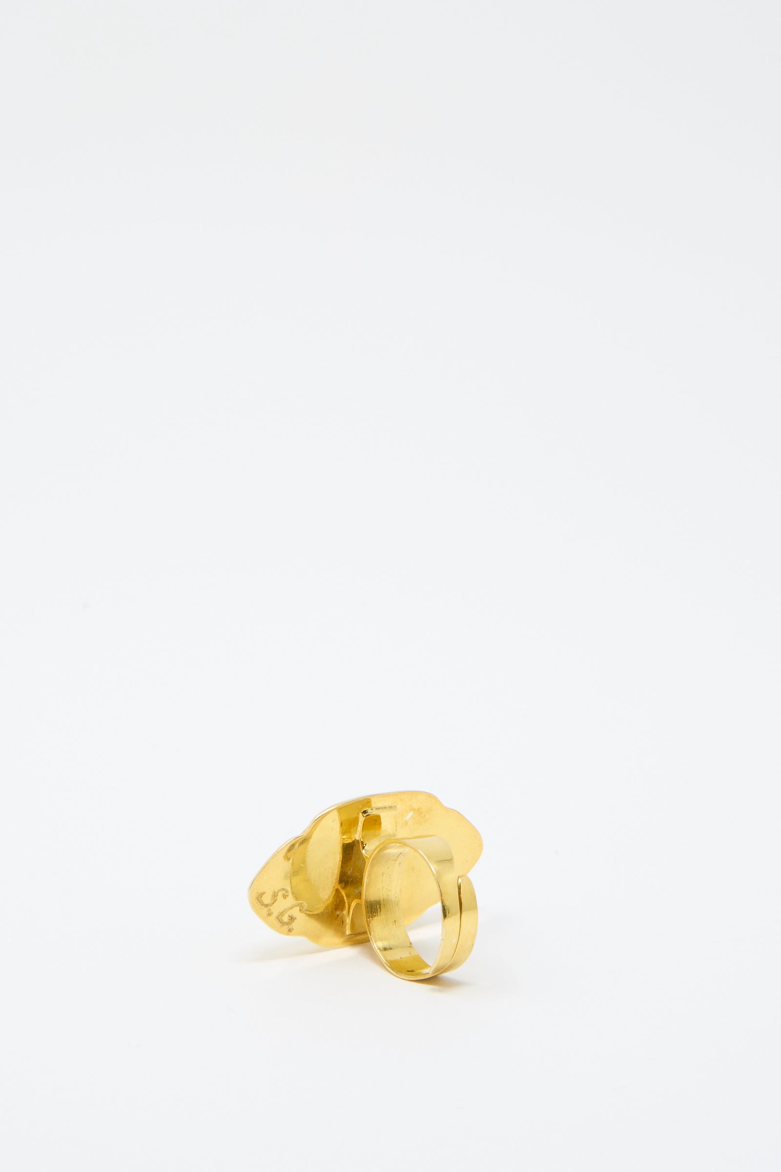 On a plain white background, a gold-backed ring from Sofio Gongli is displayed facing away from the viewer. 