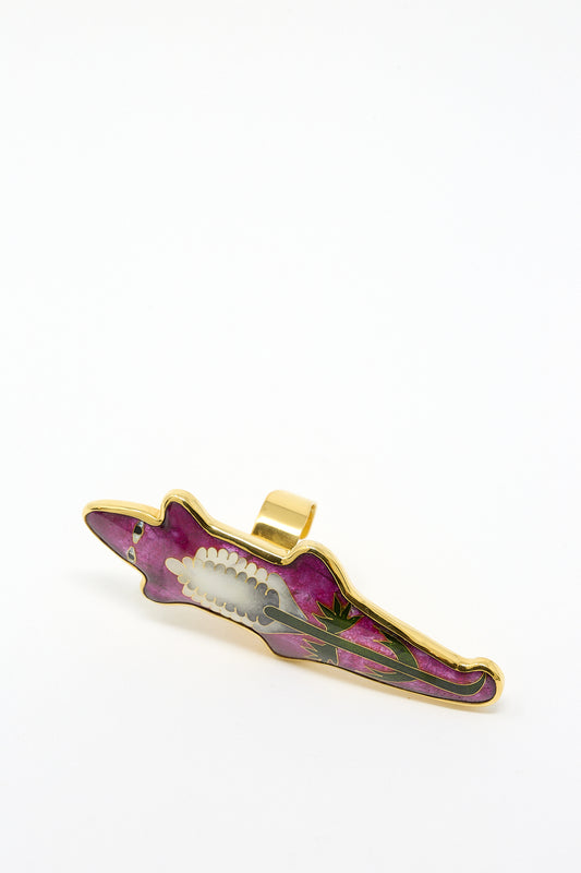 A Sofio Gongli hair clip with an enamel decorative design, featuring purple color and a floral motif, placed against a plain white background.