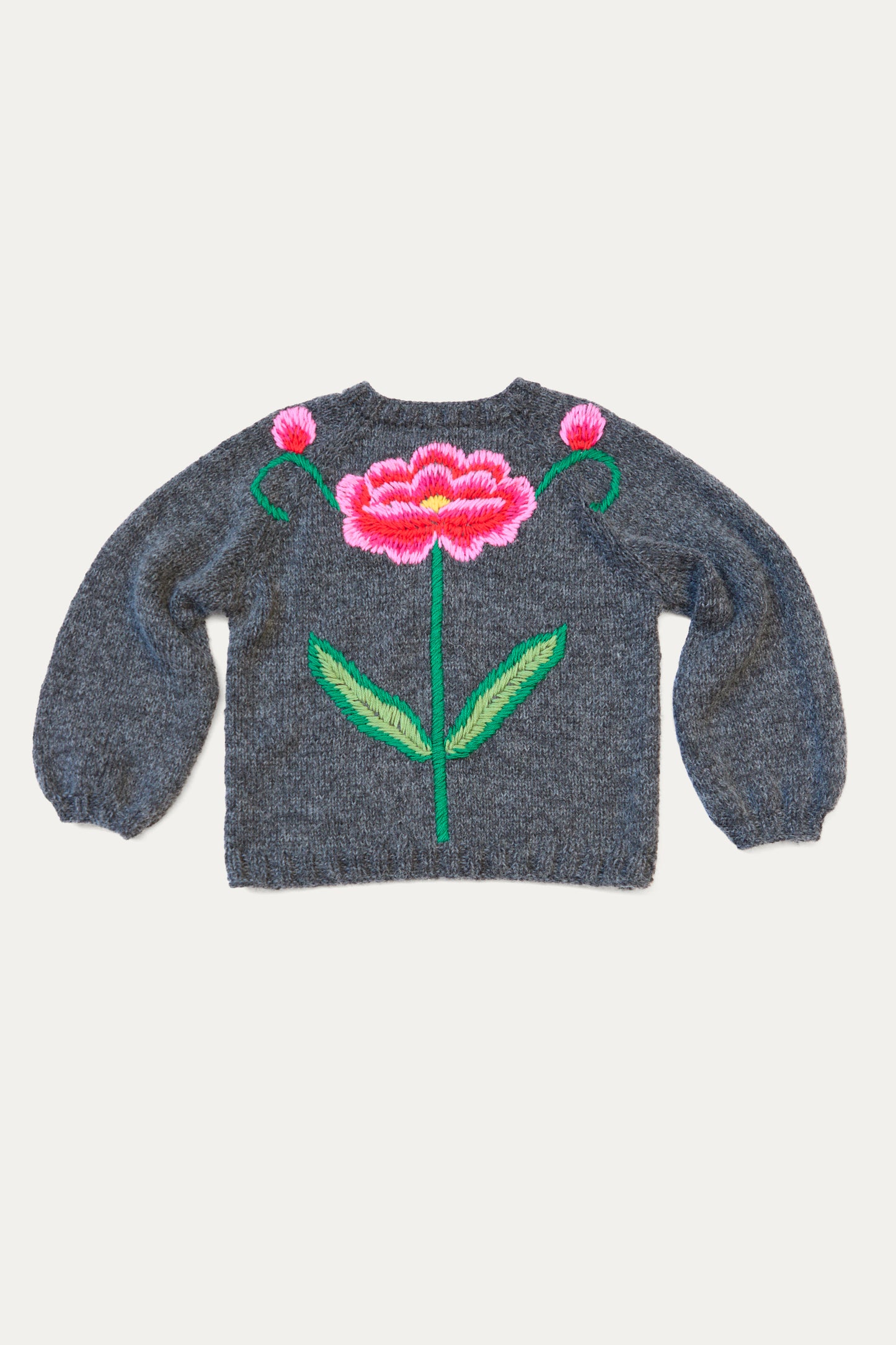 The Sofio Gongli Sweater with Red and Pink Flower in Charcoal is a hand-knit mohair wool blend with an embroidered large pink flower and green leaves on the back.