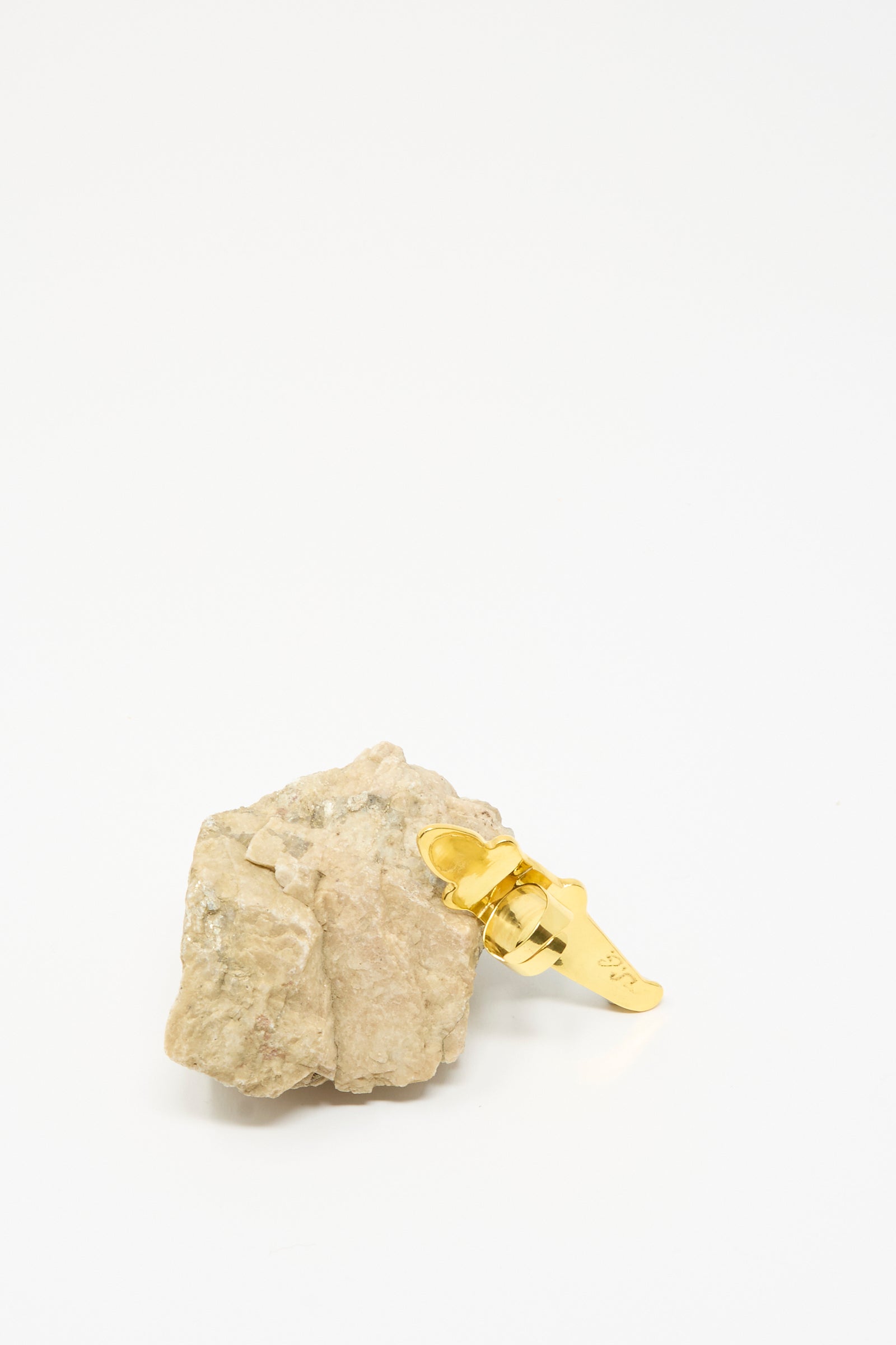 The Sofio Gongli Alligator Ring in Blue is shown attached to a rough beige rock, set against a plain white background.