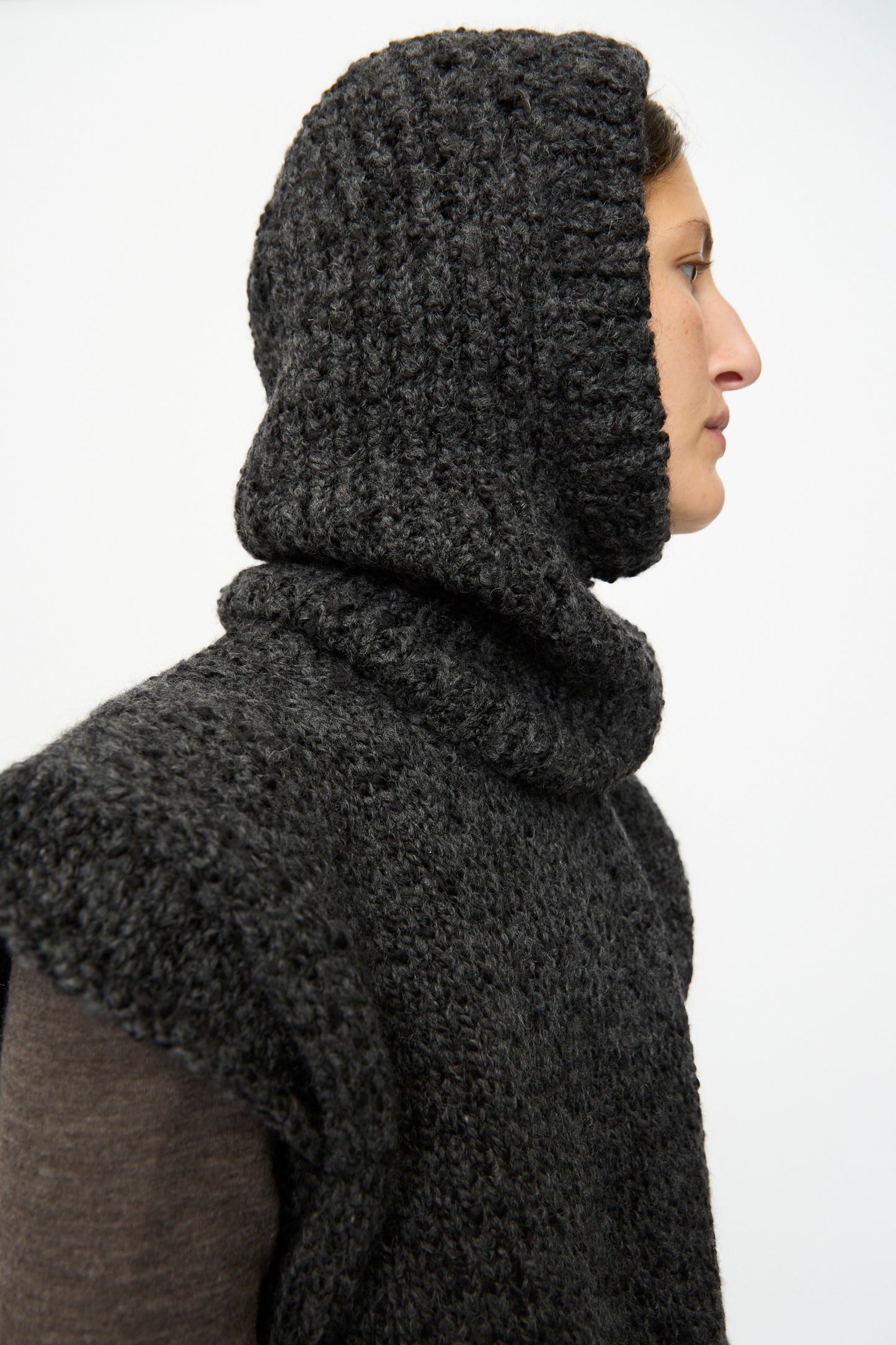 A person in profile wears the SONO Alpaca and Wool Bruna Balaclava in Charcoal over a long-sleeved shirt, set against a plain light background.