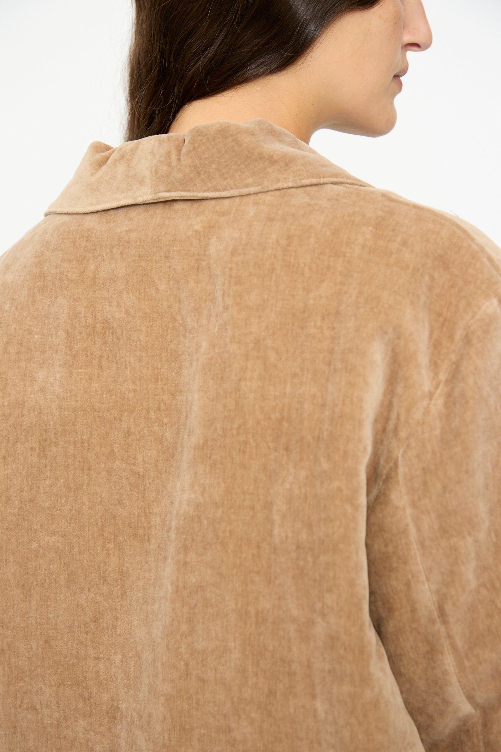A close-up shows a person wearing the SONO Yoyogi Jacket in Desert Rose, featuring an oversized corduroy texture, viewed from the back and side against a plain background.