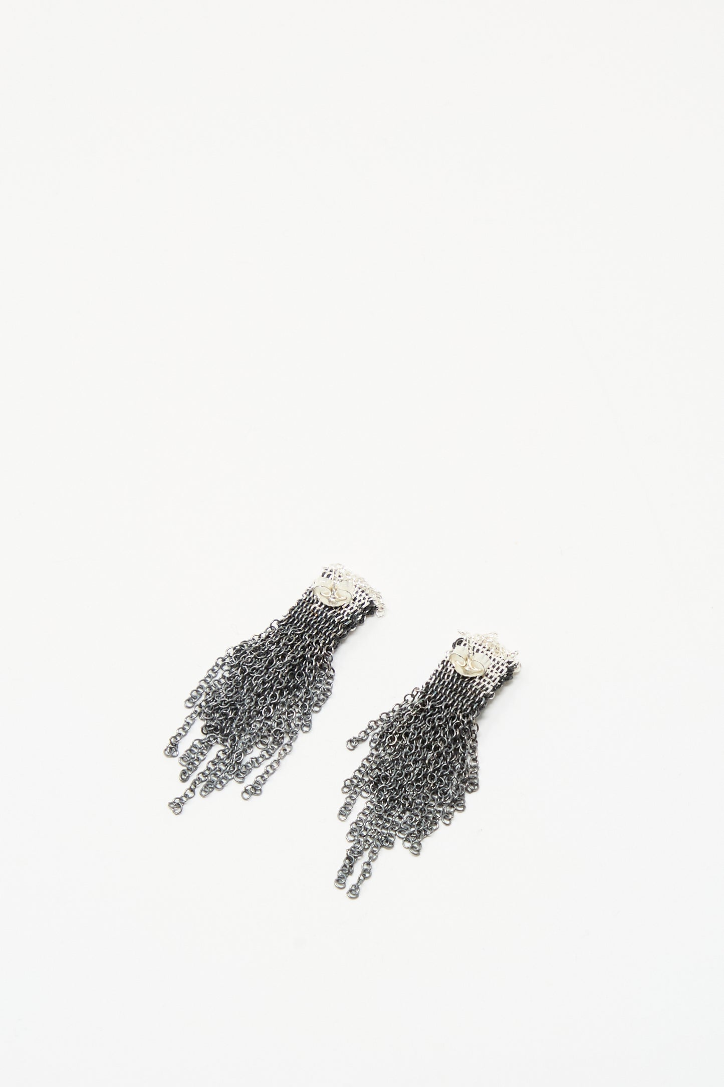 Stephanie Schneider Sterling Silver Oxidized and Silk Earrings in Anthracite, featuring multiple fringe strands, are displayed on a white background.