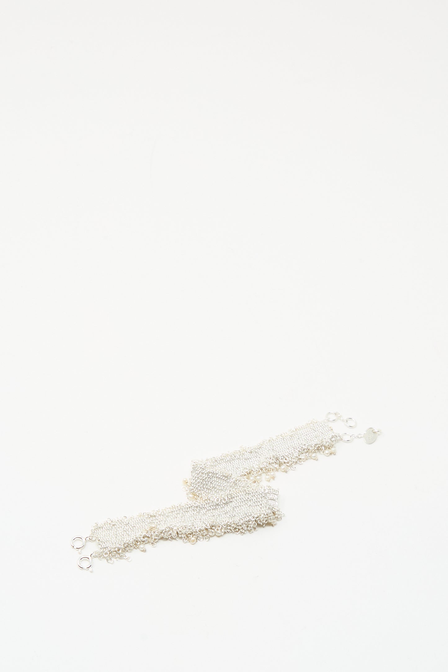 The Stephanie Schneider Silver and Silk Woven Bracelet with Pearls is displayed on a plain white background.