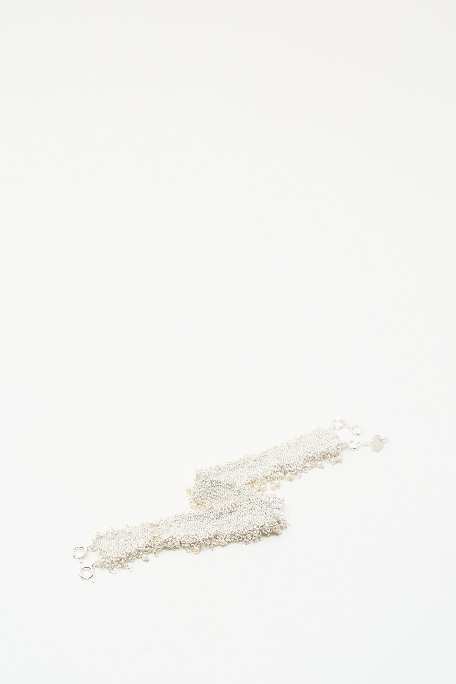 The Stephanie Schneider Silver and Silk Woven Bracelet with Pearls is displayed on a plain white background.