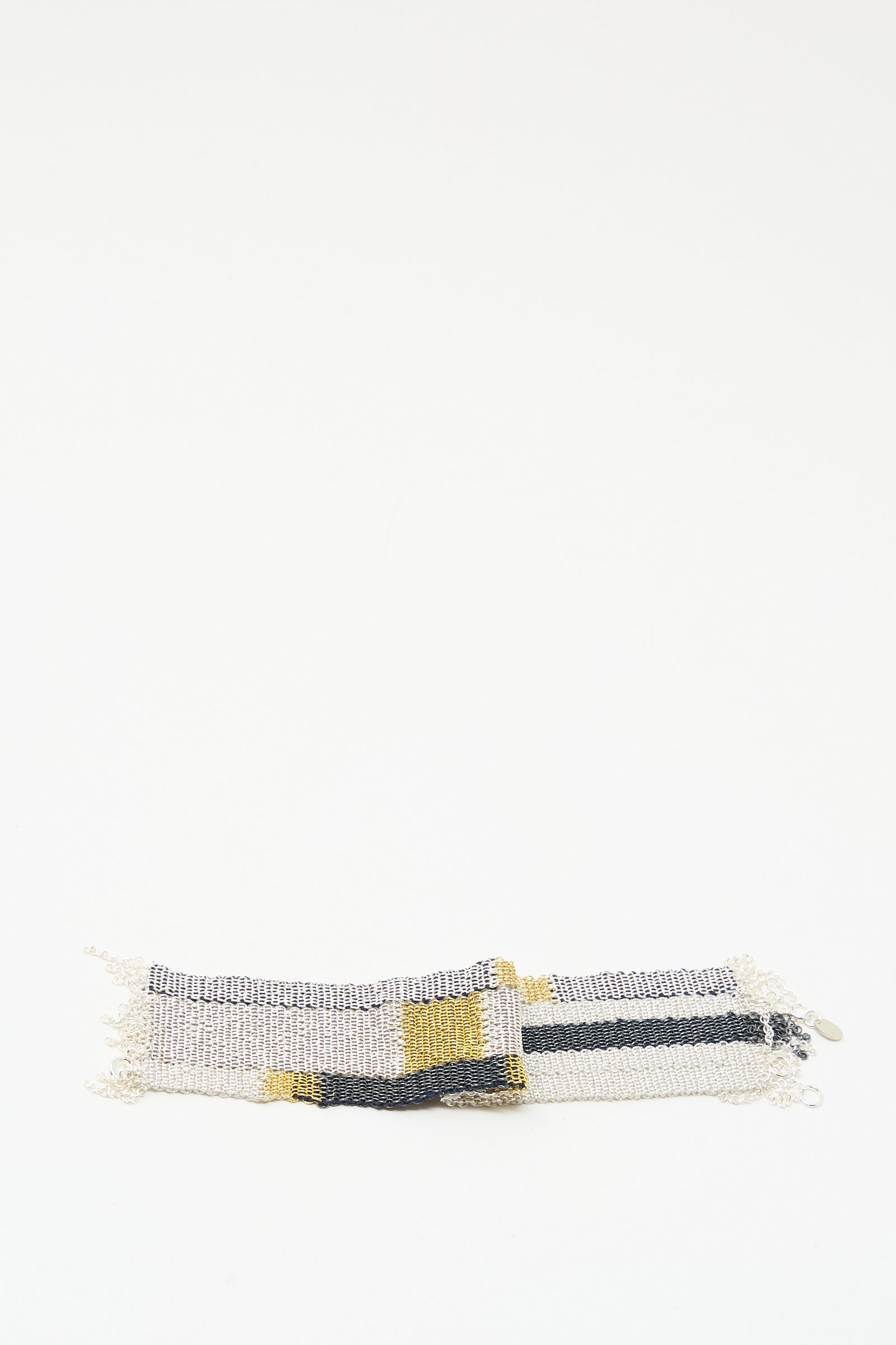 The Stephanie Schneider Silver Oxidized, Gold Plated and Silk Woven Bracelet with silver, black, and yellow stripes is shown on a plain white background.