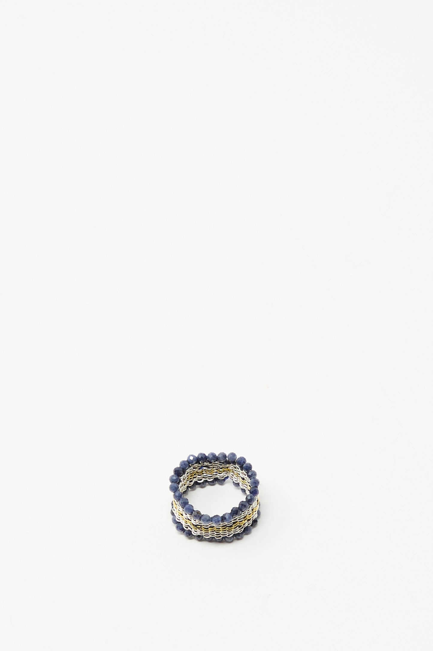 The Stephanie Schneider Silver, Gold Plated and Silk Woven Ring with Blue Sapphires is displayed on a plain white background.