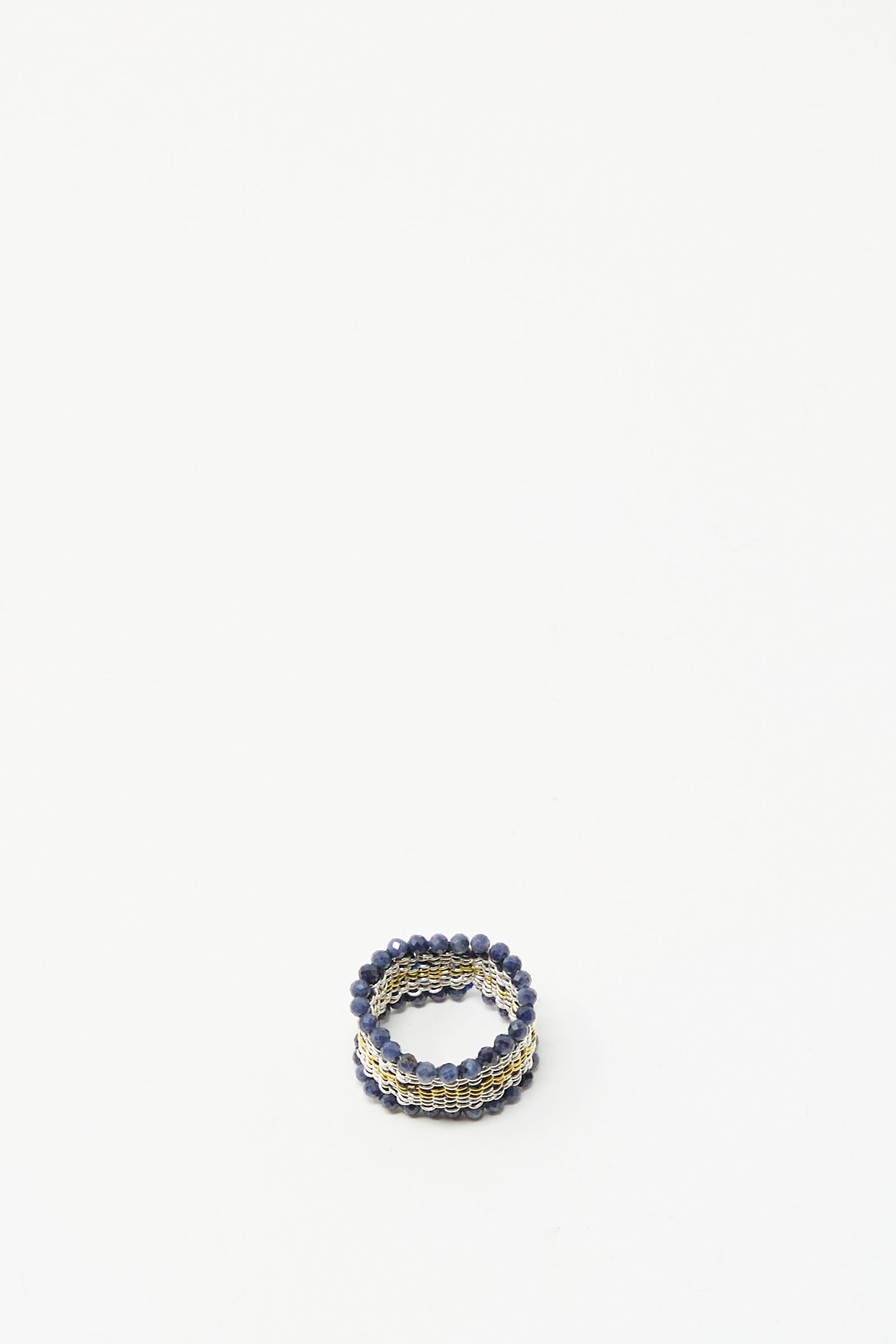 The Stephanie Schneider Silver, Gold Plated and Silk Woven Ring with Blue Sapphires is displayed on a plain white background.