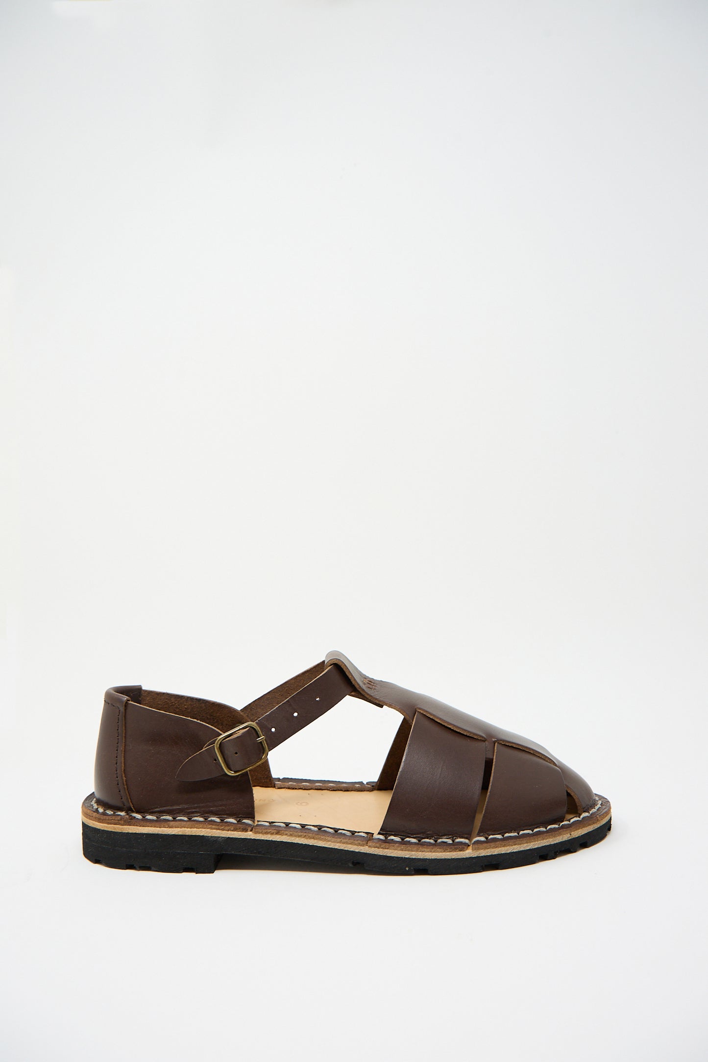 A single Vegetable Tanned Calfskin Artisanal Sandal in Coffee by Steve Mono, sustainably made with a closed-toe design and buckle strap, is displayed against a plain white background.