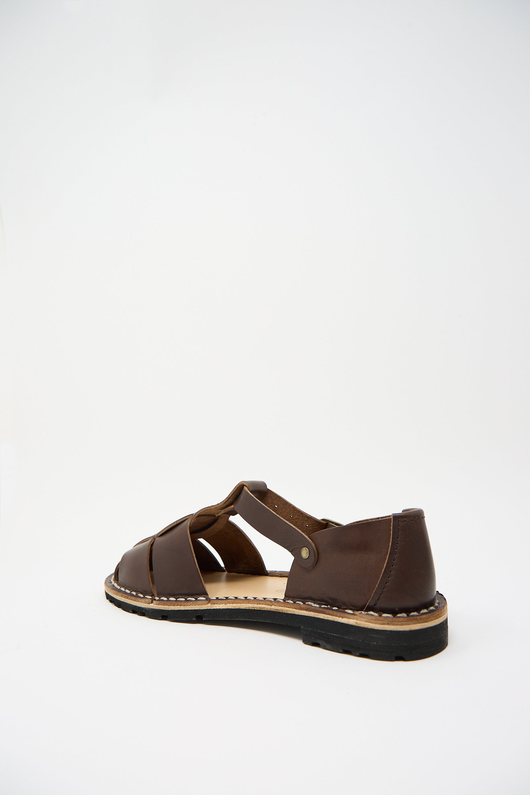 A single Steve Mono Vegetable Tanned Calfskin Artisanal Sandal in Coffee with an open-toe design and a black sole, sustainably made and displayed against a plain white background.