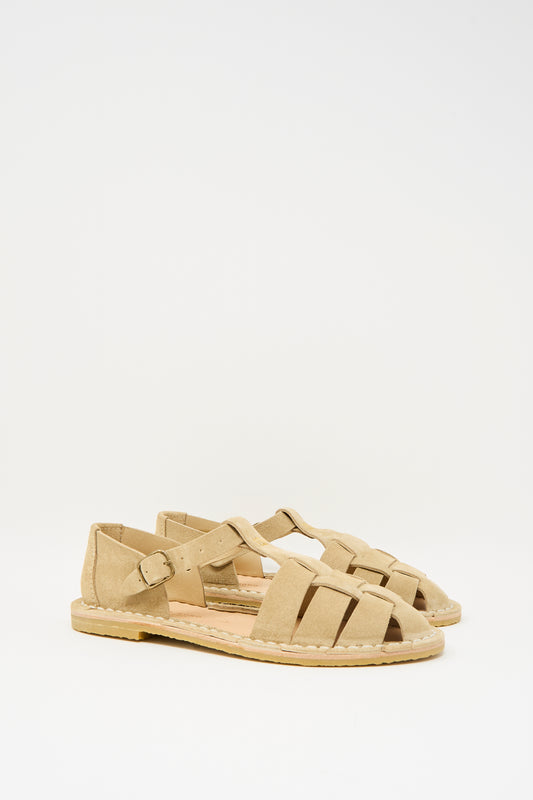 The Steve Mono Suede Artisanal Sandal 10/01 in Light Camel is a pair of beige, closed-toe suede calfskin sandals with woven straps, a side buckle, and a recycled rubber sole, shown against a plain white background.