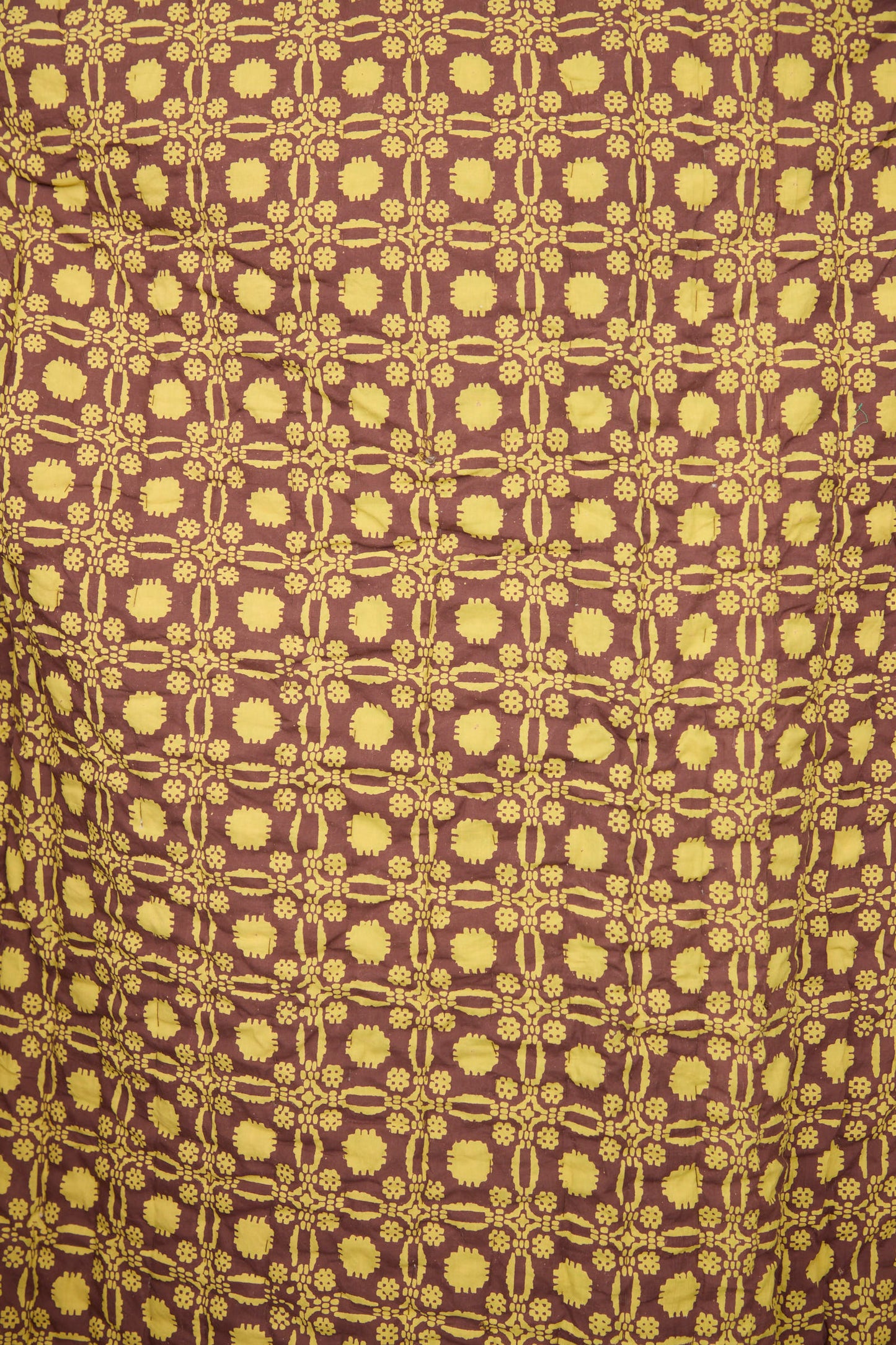 The Studio Ford Thatcher Quilt 100 x 108" features yellow floral and geometric patterns on a brown block-printed percale cotton background, creating a striking handmade effect.