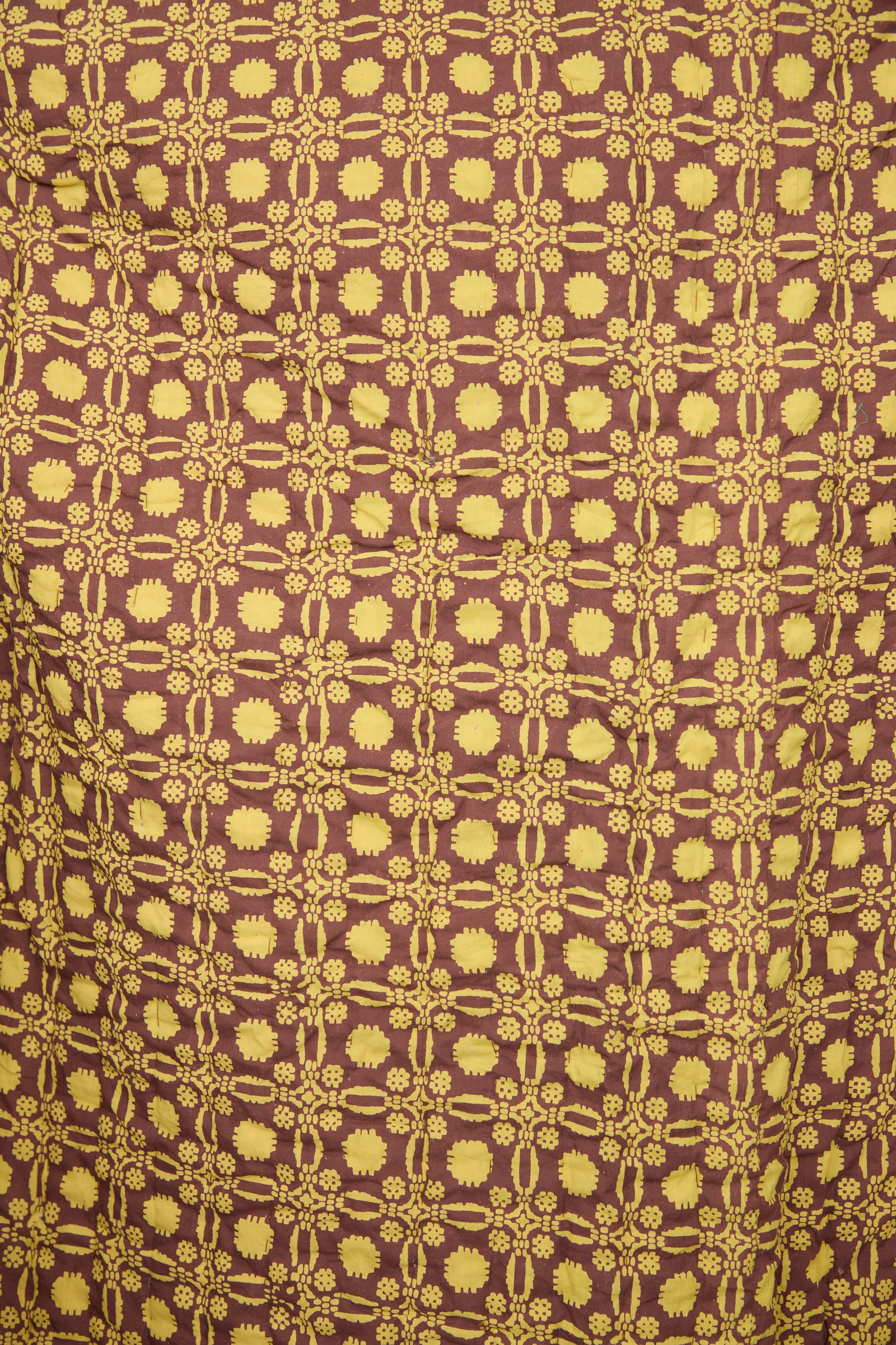 The Studio Ford Thatcher Quilt 100 x 108" features yellow floral and geometric patterns on a brown block-printed percale cotton background, creating a striking handmade effect.