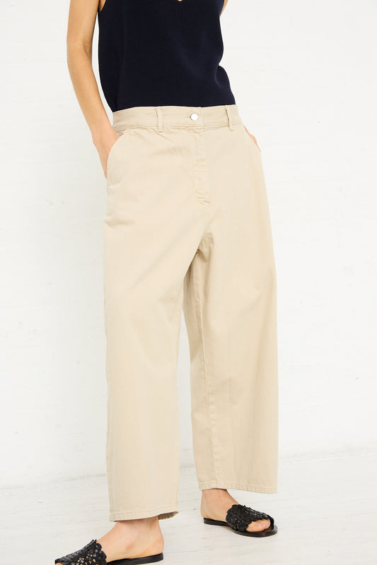 A person standing in Studio Nicholson's Denim Chalco Wide Crop Pant in Dove and a navy top, with a white background. Only the lower half of the body is visible.
