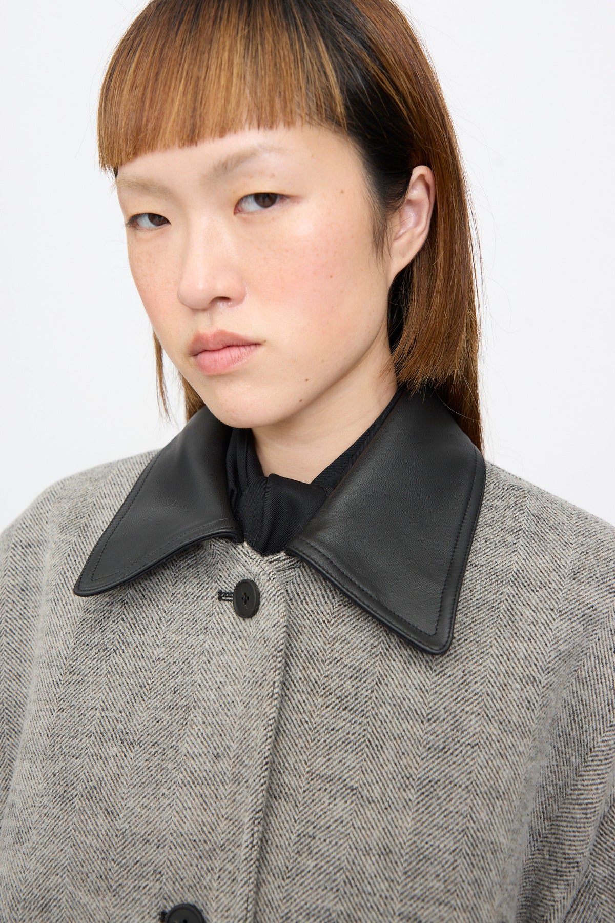 Person wearing a black and white herringbone Seberg Chore Jacket with a black collar.