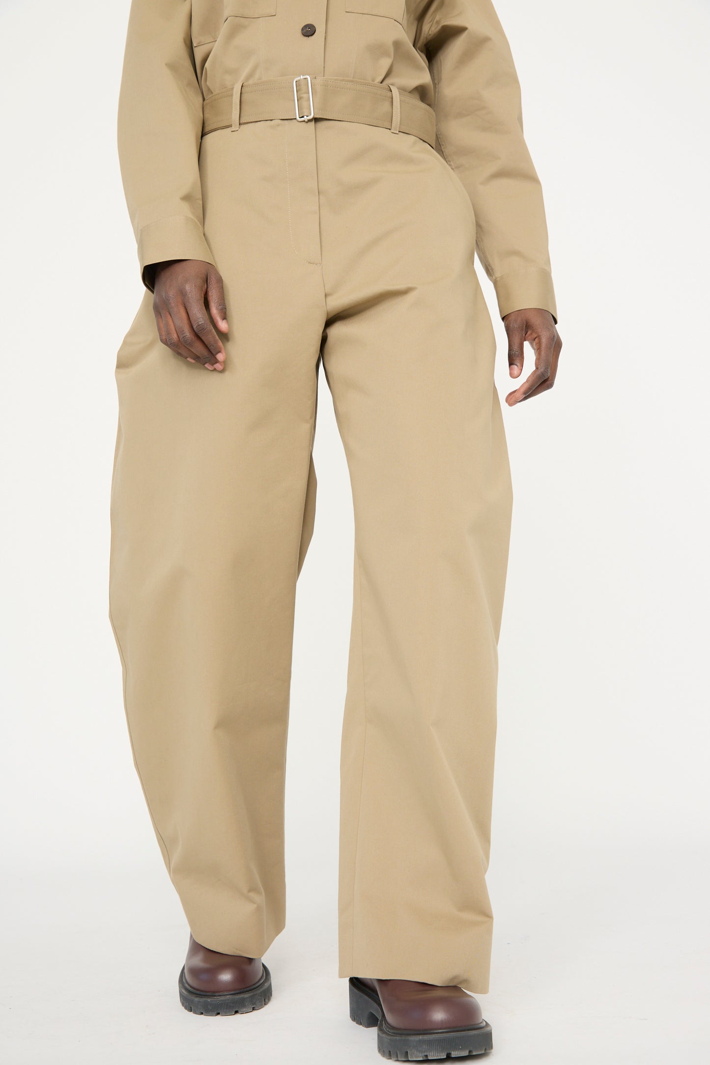 Person in Studio Nicholson's Soft Technical Twill Doring Pant in Parcel with a matching top and belt, set against a plain background. 