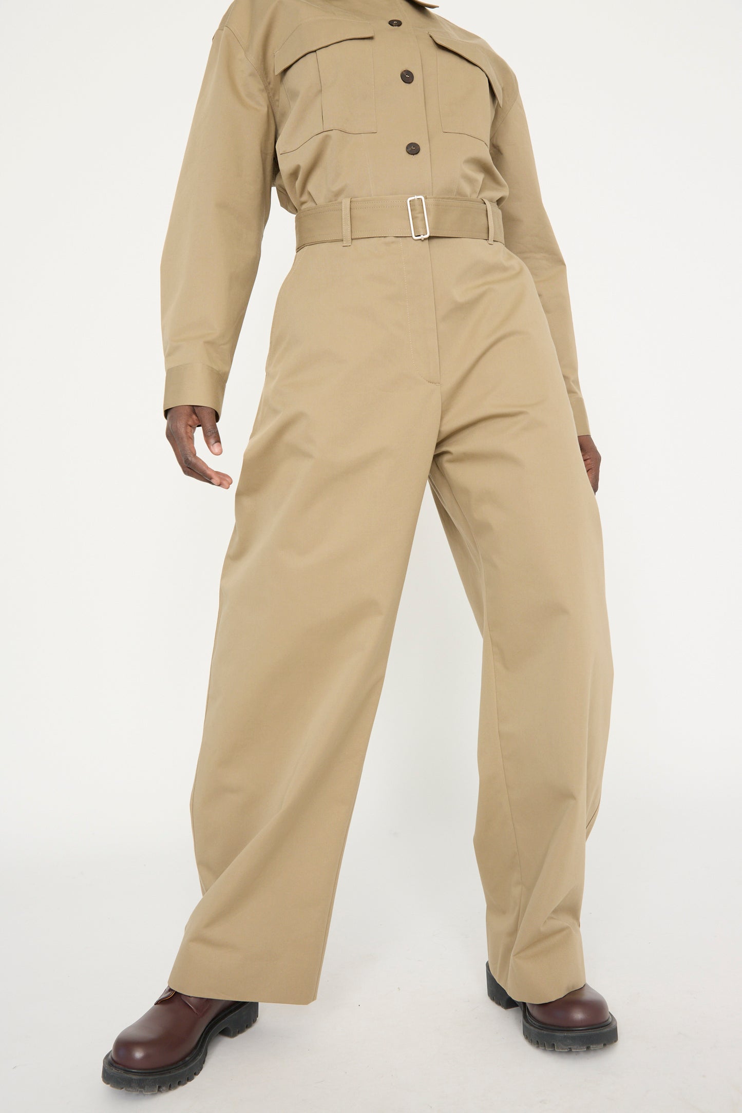 A model wearing Studio Nicholson's Soft Technical Twill Doring Pant in Parcel with dark brown shoes, standing against a plain white background.