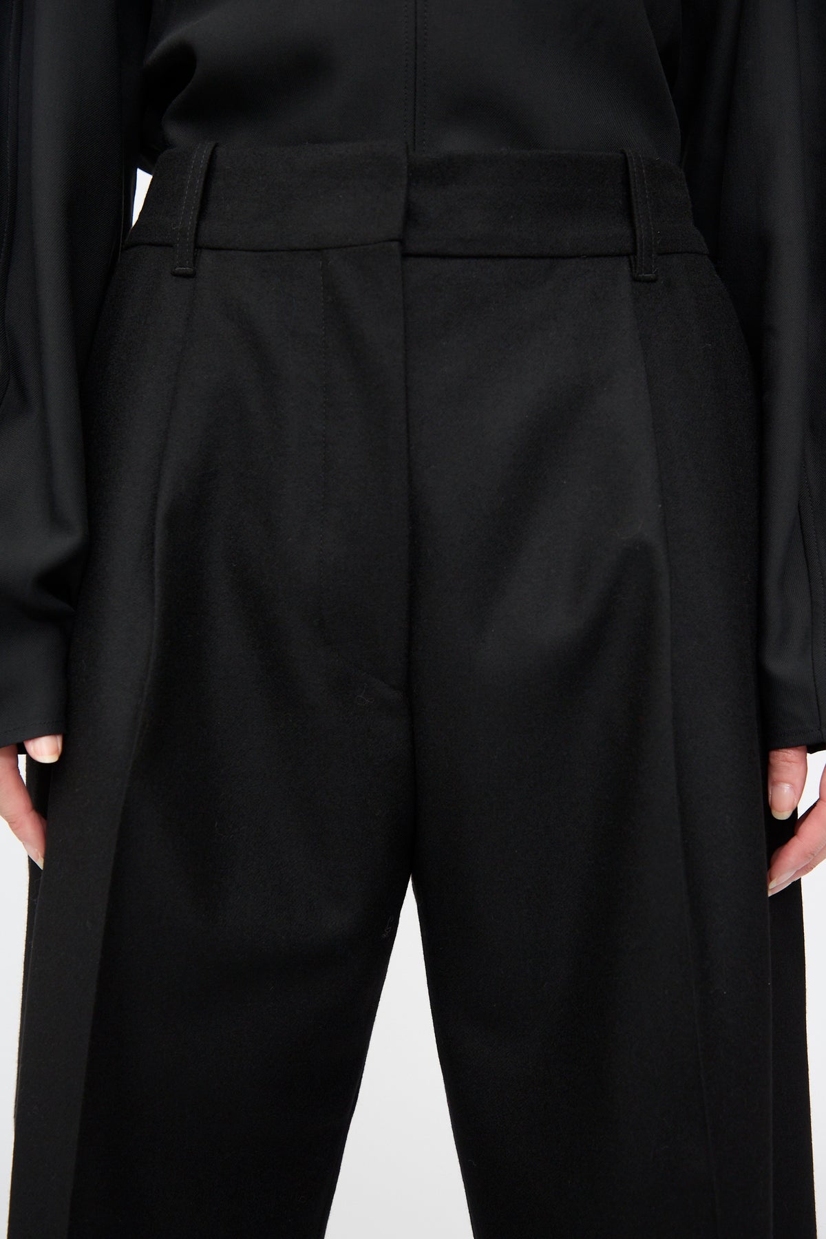 Studio Nicholson Sperro Double Pleat Pant in black virgin wool with double pleats at the waist and a tapered leg.
