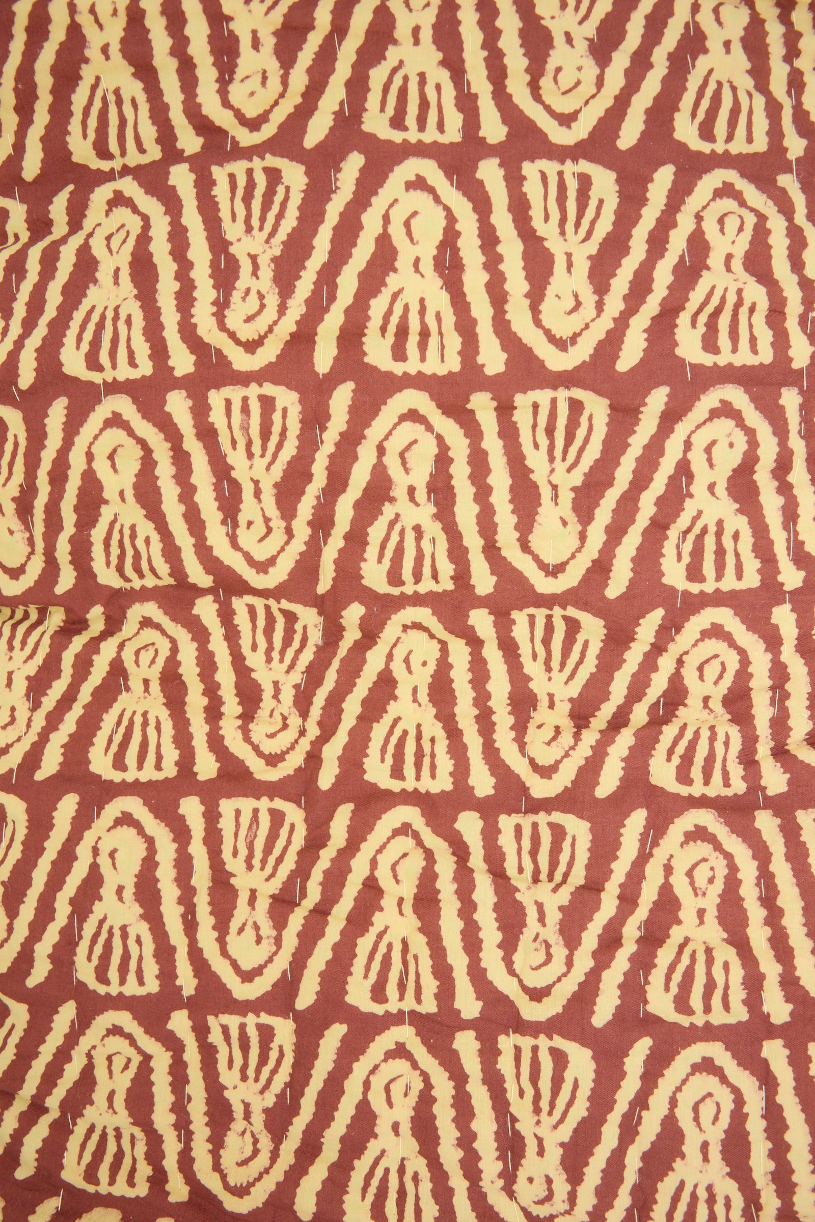 The Wild Shroom Quilt 100 x 108" by Studio Ford features cream geometric shapes on a reddish-brown block-printed percale cotton background, offering an artisanal, unique design.