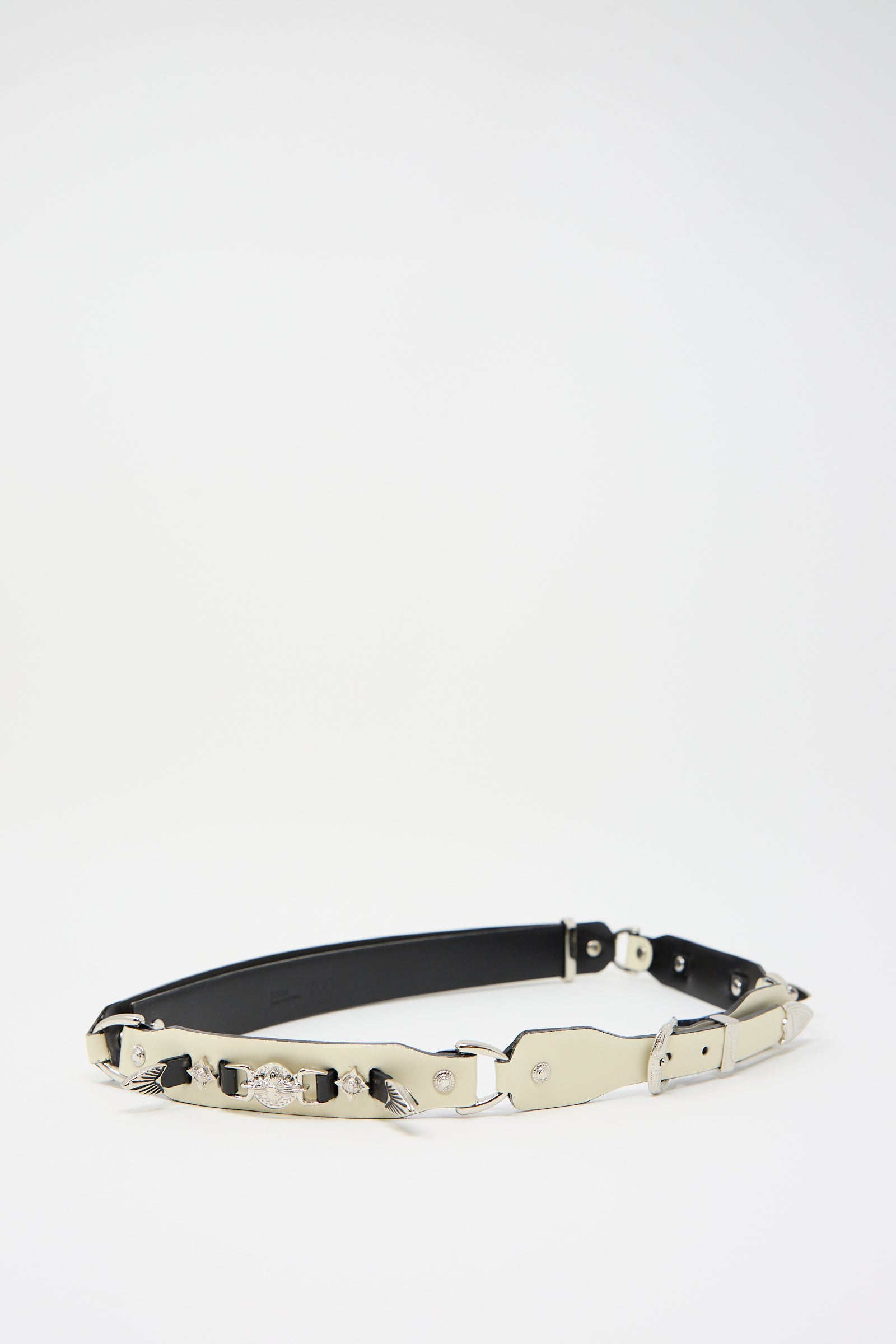 An Off White Metal Leather Narrow Belt by TOGA ARCHIVES, blending leather and metal materials in a Western-inspired design. This adjustable piece features silver metallic plates and embellishments, displayed against a plain white background.