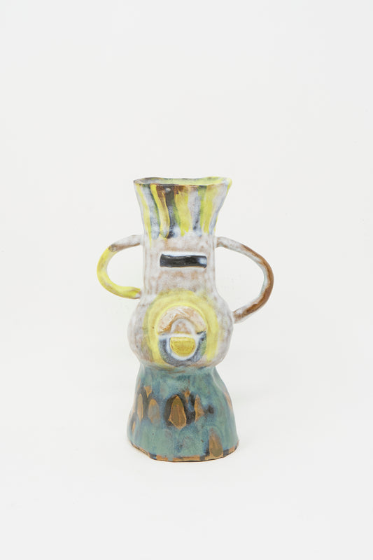 The A New Friend Candle Holder V by Tamar Mogendorff features two side handles, abstract shapes, and a multicolored glaze in yellow, white, brown, and green—handmade in Brooklyn and shown against a plain white background.