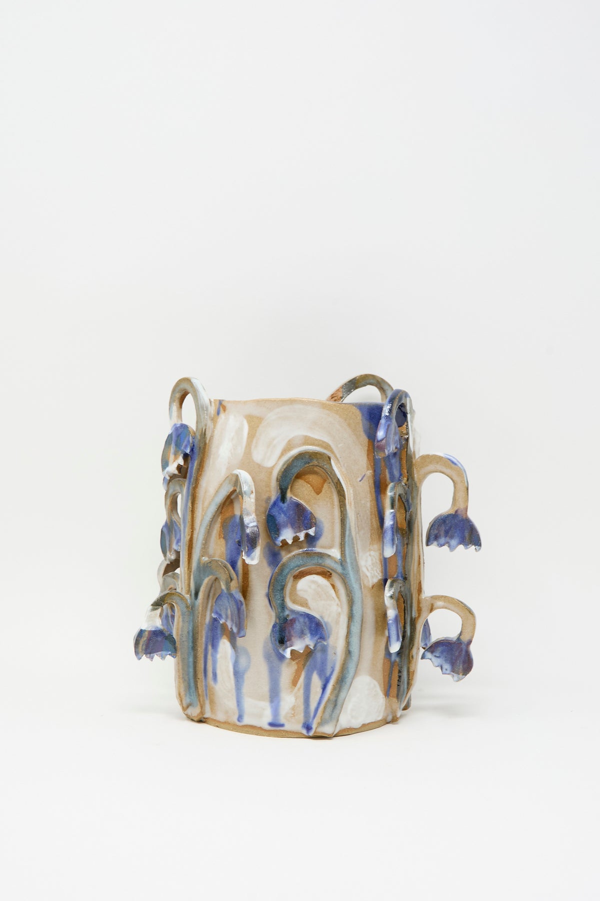 Bluebell Field Vase by Tamar Mogendorff, a hand-built ceramic vase featuring blue-glazed bell-shaped flowers on trailing stems, handmade in Brooklyn.