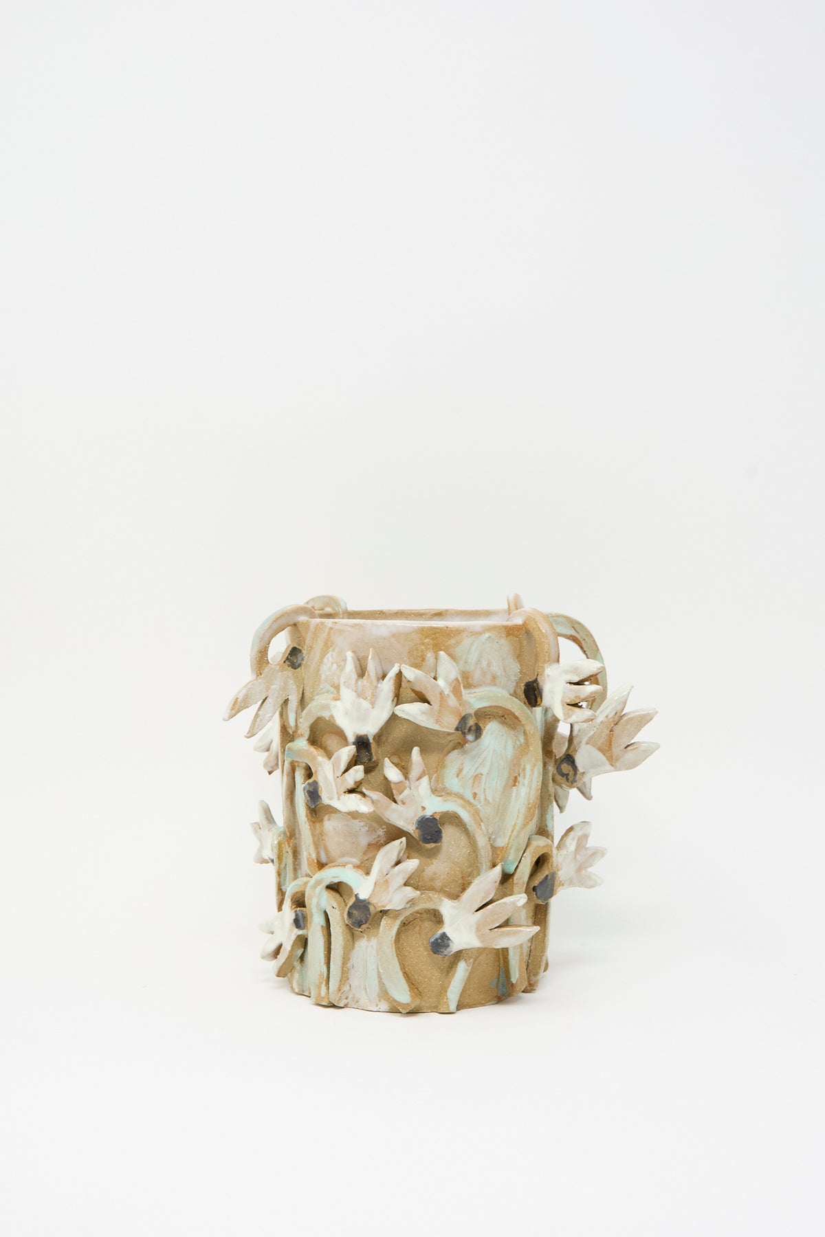 Cyclamens Field Vase by Tamar Mogendorff, a cylindrical handmade ceramic vase decorated with raised, sculpted flower embellishments.