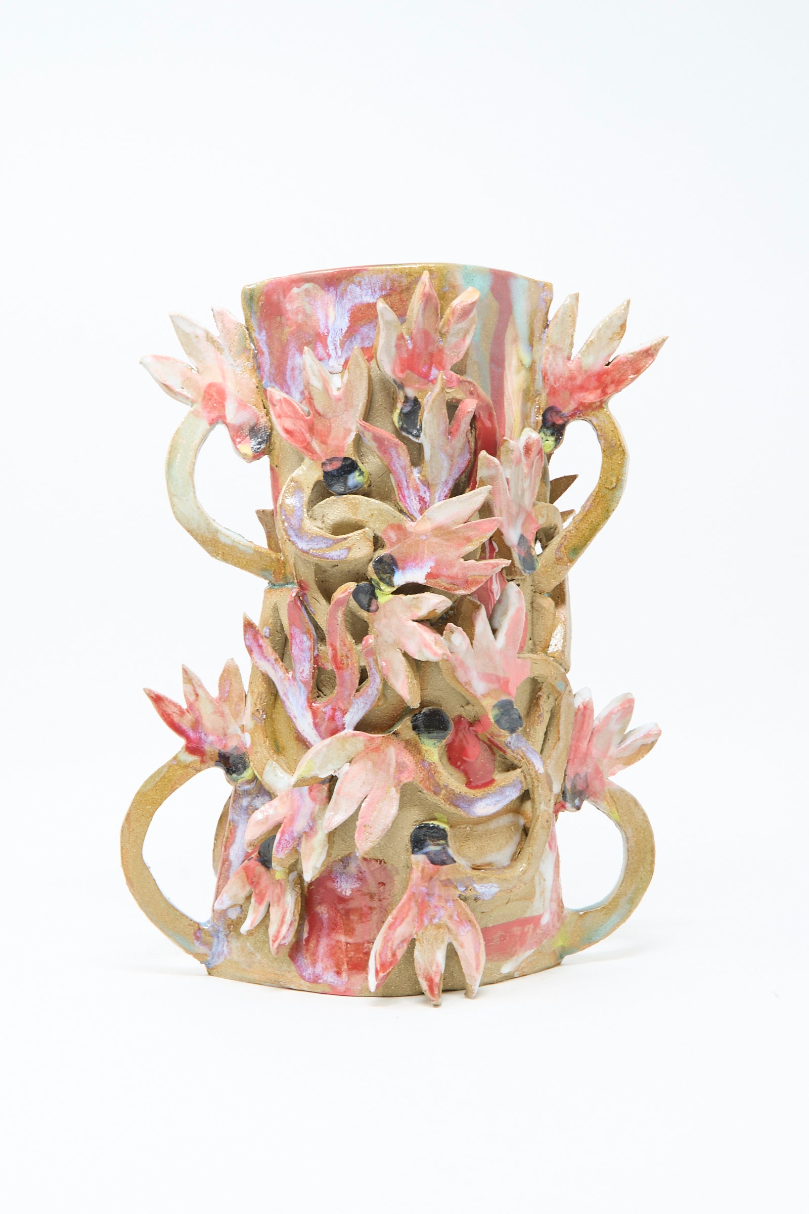 The Cyclamens in the Wild Vase by Tamar Mogendorff is a cylindrical ceramic piece adorned with pink and red sculpted flowers and green leaves winding around its surface, creating a charming floral accent.