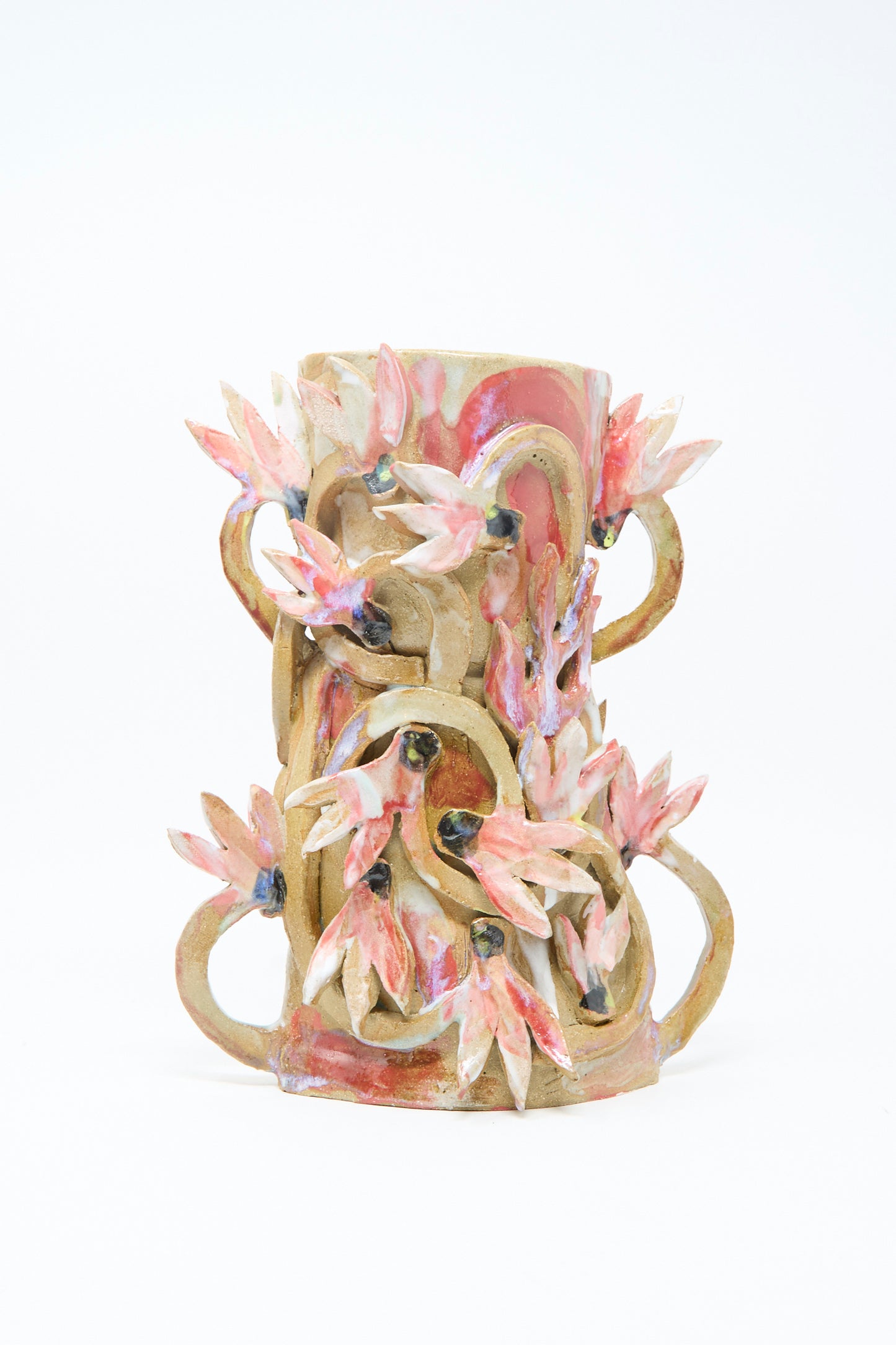 The Cyclamens in the Wild Vase by Tamar Mogendorff features double handles with intricate curls and pink, flower-inspired sculpted details, all set against a plain white background.