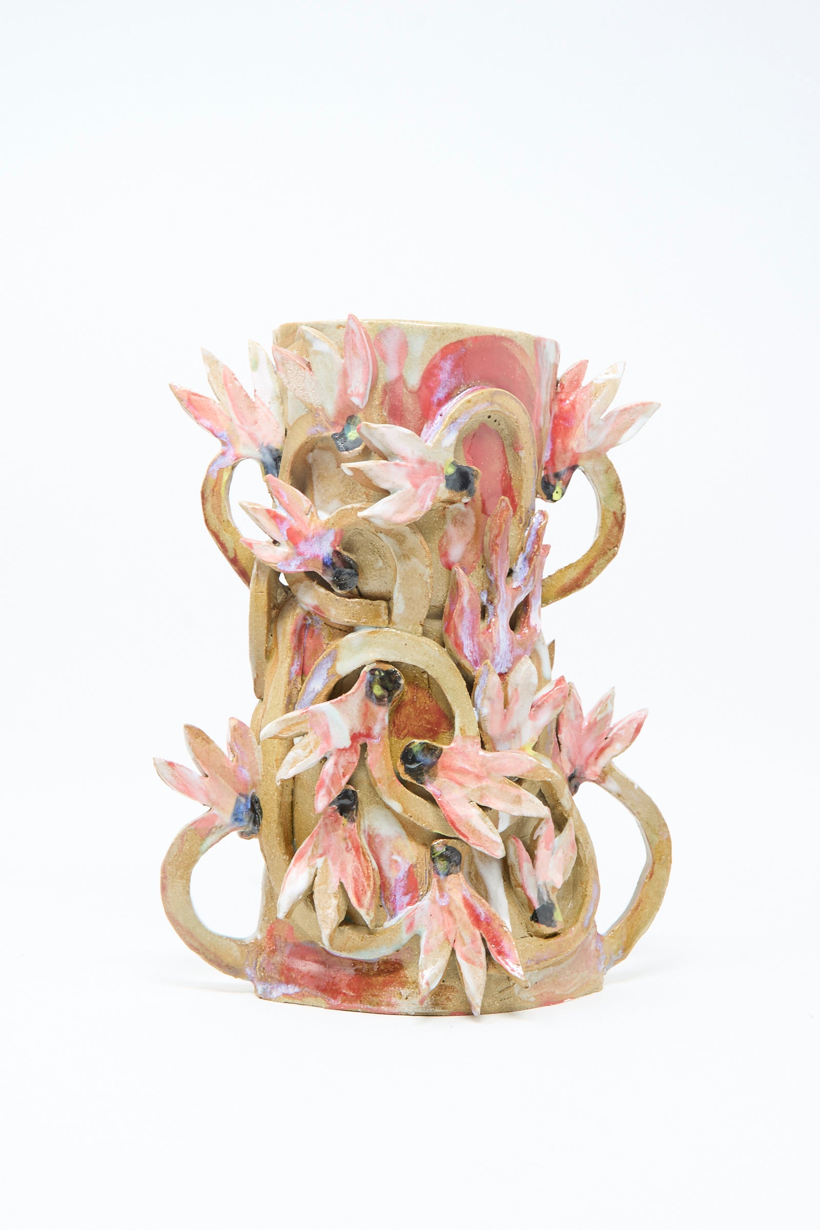 The Cyclamens in the Wild Vase by Tamar Mogendorff features double handles with intricate curls and pink, flower-inspired sculpted details, all set against a plain white background.