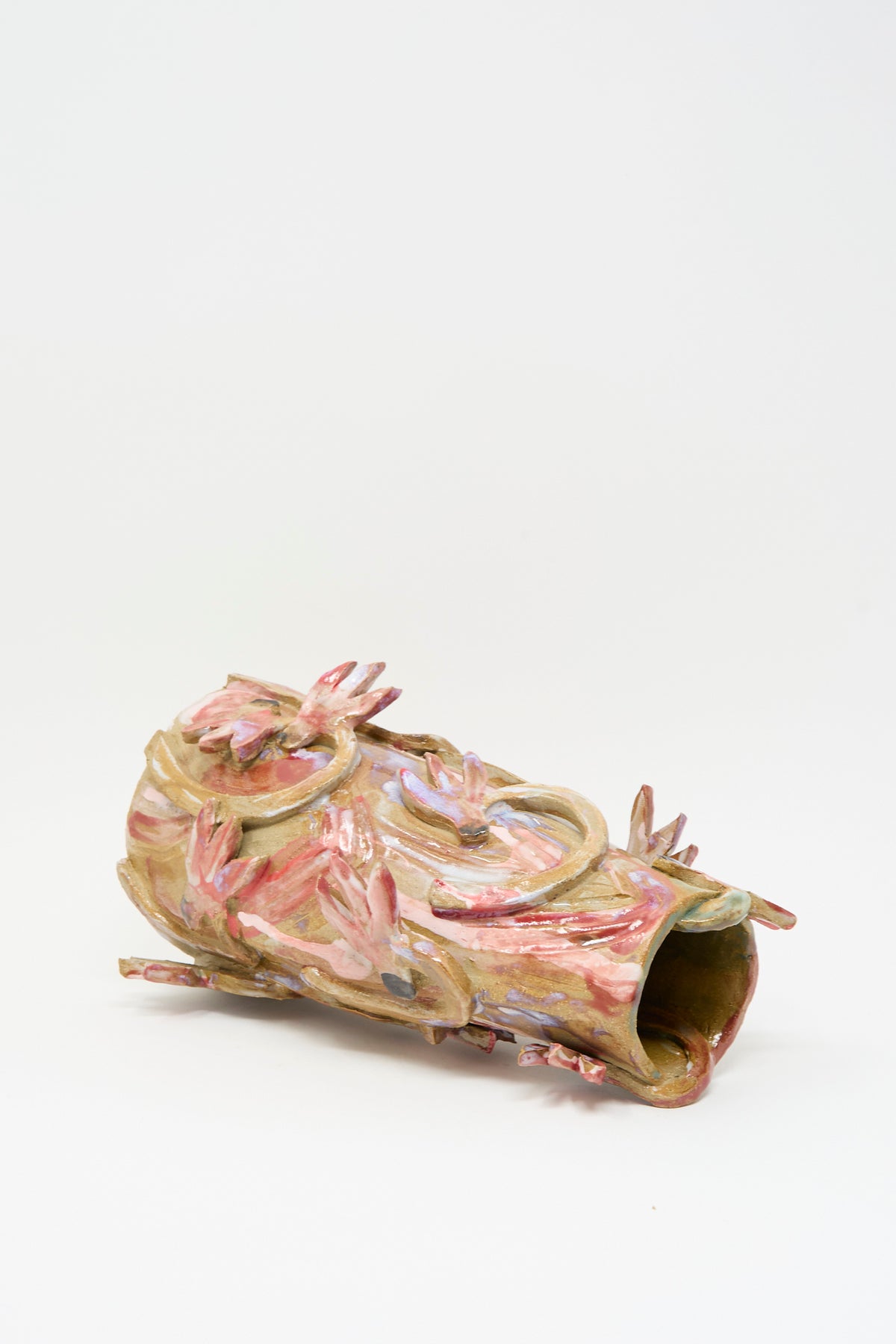 A Cyclamens in the Wild Vase I, featuring a handmade cylindrical ceramic design decorated with raised, abstract pink and light purple floral shapes in a multicolored glaze.