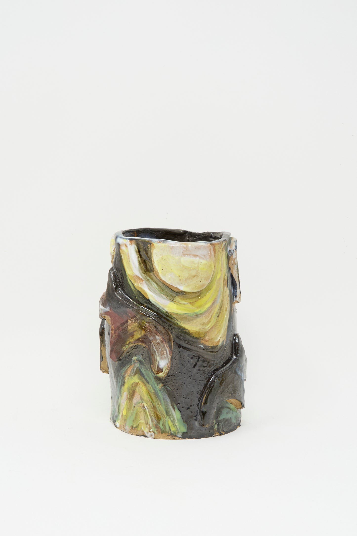 The Donkeys in the Moonshine vase by Tamar Mogendorff is a handmade cylindrical ceramic piece from Brooklyn, with an uneven rim and swirling yellow, green, brown, and black glazes across its surface.