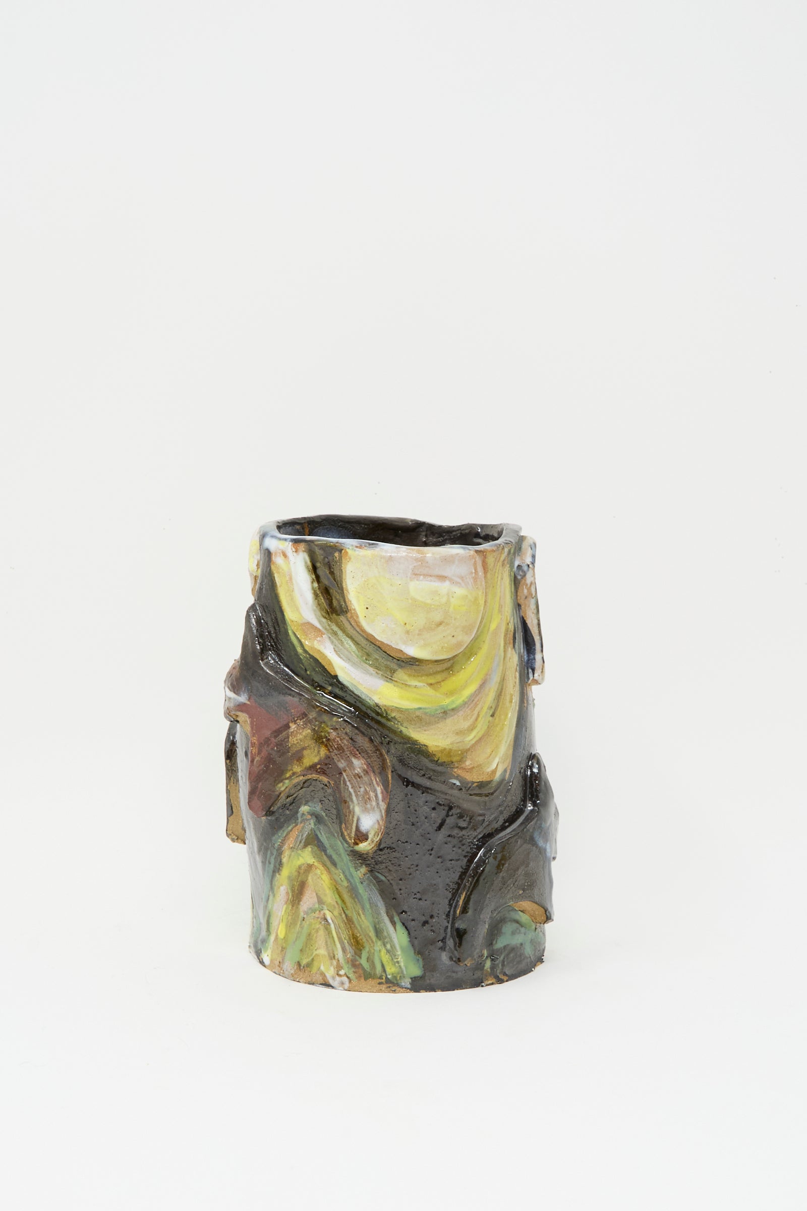 The Donkeys in the Moonshine vase by Tamar Mogendorff is a handmade cylindrical ceramic piece from Brooklyn, with an uneven rim and swirling yellow, green, brown, and black glazes across its surface.