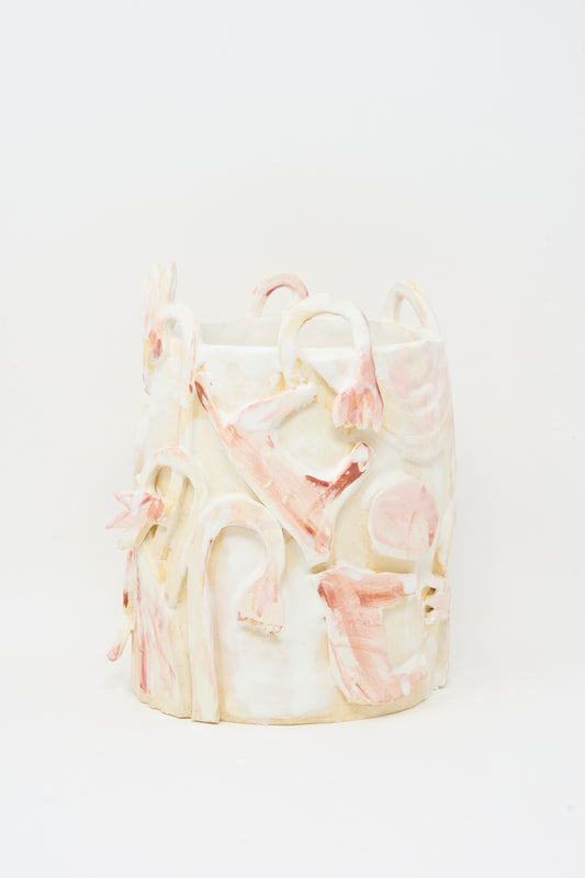 The Foggy Day Vase by Tamar Mogendorff is a cylindrical ceramic piece from Brooklyn, featuring abstract pink and cream raised designs with delicate floral motifs on a white background.