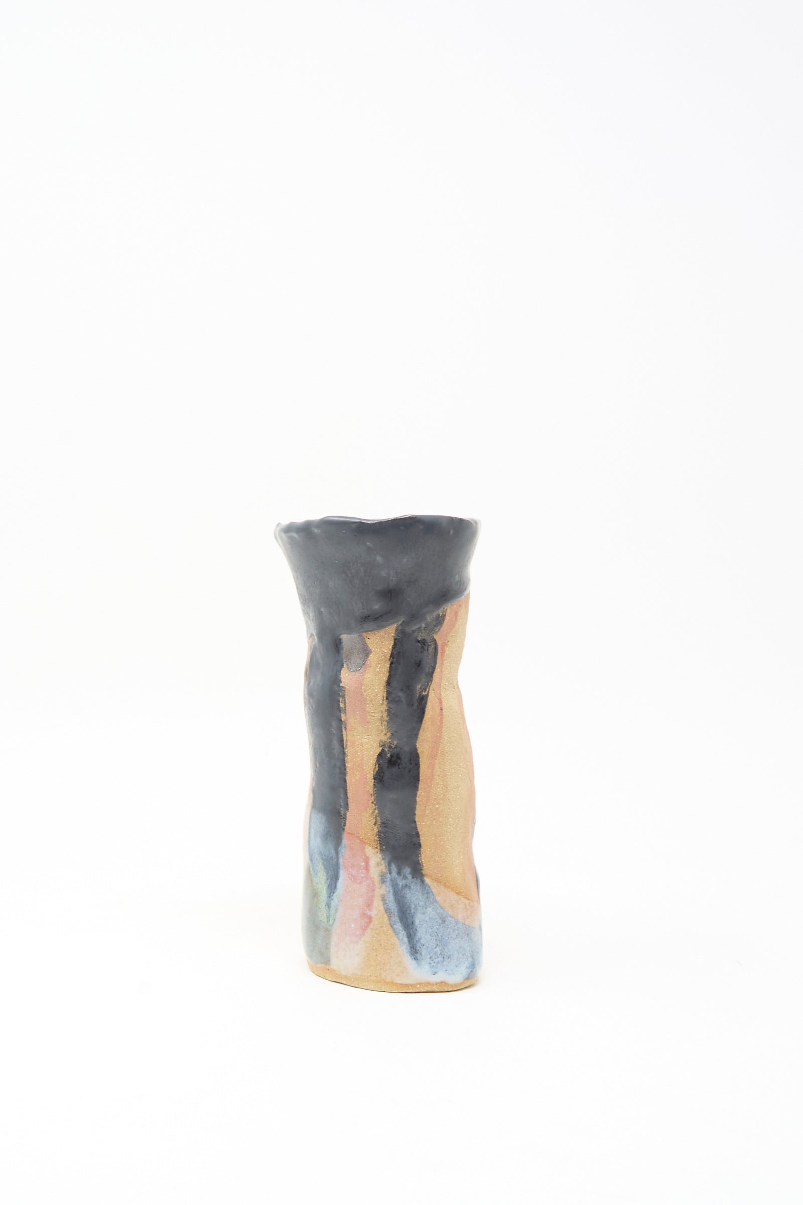 The "I wish I knew them Candleholder I" by Tamar Mogendorff is a small, hand-shaped ceramic piece with a wavy rim and black, blue, and pink streaks over tan, made in Brooklyn and shown on a plain white background.
