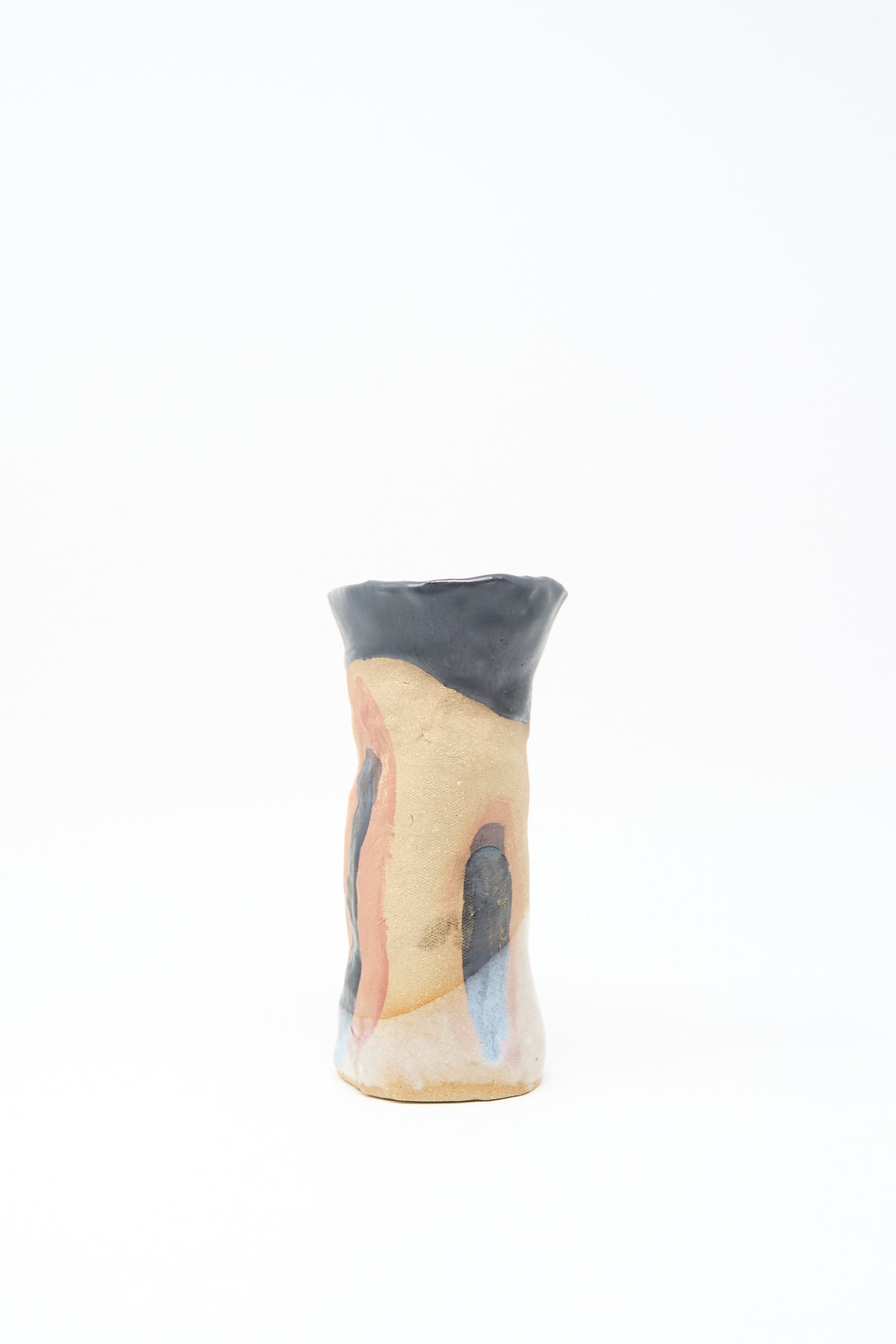 Tamar Mogendorff’s I wish I knew them Candleholder I is a handmade ceramic piece with an irregular shape, beige base, blue and terra cotta abstract patterns, glossy black rim, and subtle black and orange accents, set on a white background.