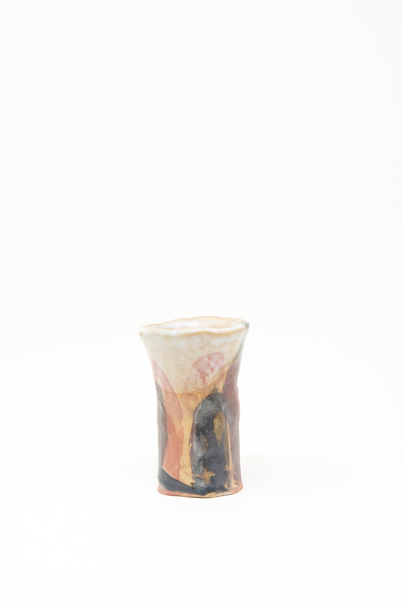 Handmade in Brooklyn, the "I wish I knew them Candleholder III" by Tamar Mogendorff is a small ceramic piece with a flared rim and abstract multicolored glaze patterns in pink, beige, black, and orange on a white background.