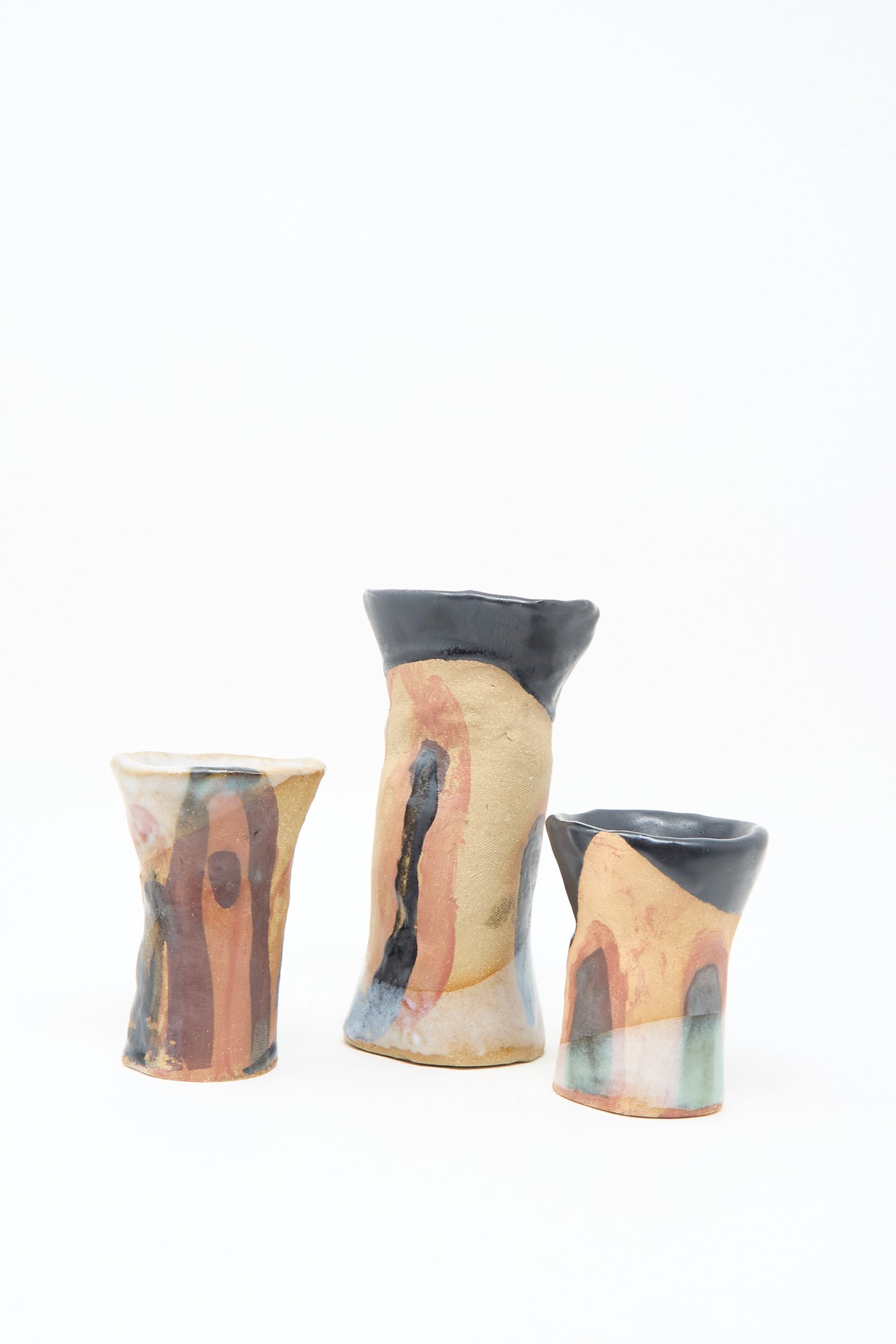 The "I wish I knew them Candleholder III" by Tamar Mogendorff features an irregular ceramic form with abstract multicolored glaze in earthy tones plus black and orange rims, highlighting Brooklyn craftsmanship against a white background.