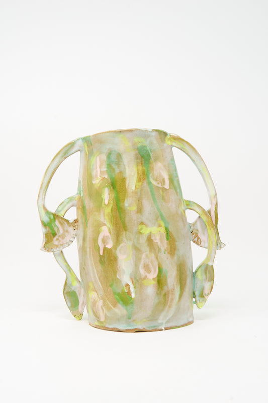 Handmade in Brooklyn, the Papyrus Bloom Vase by Tamar Mogendorff features a glossy green and beige finish with four curved, floral handles that resemble elegant plant stems or vines.