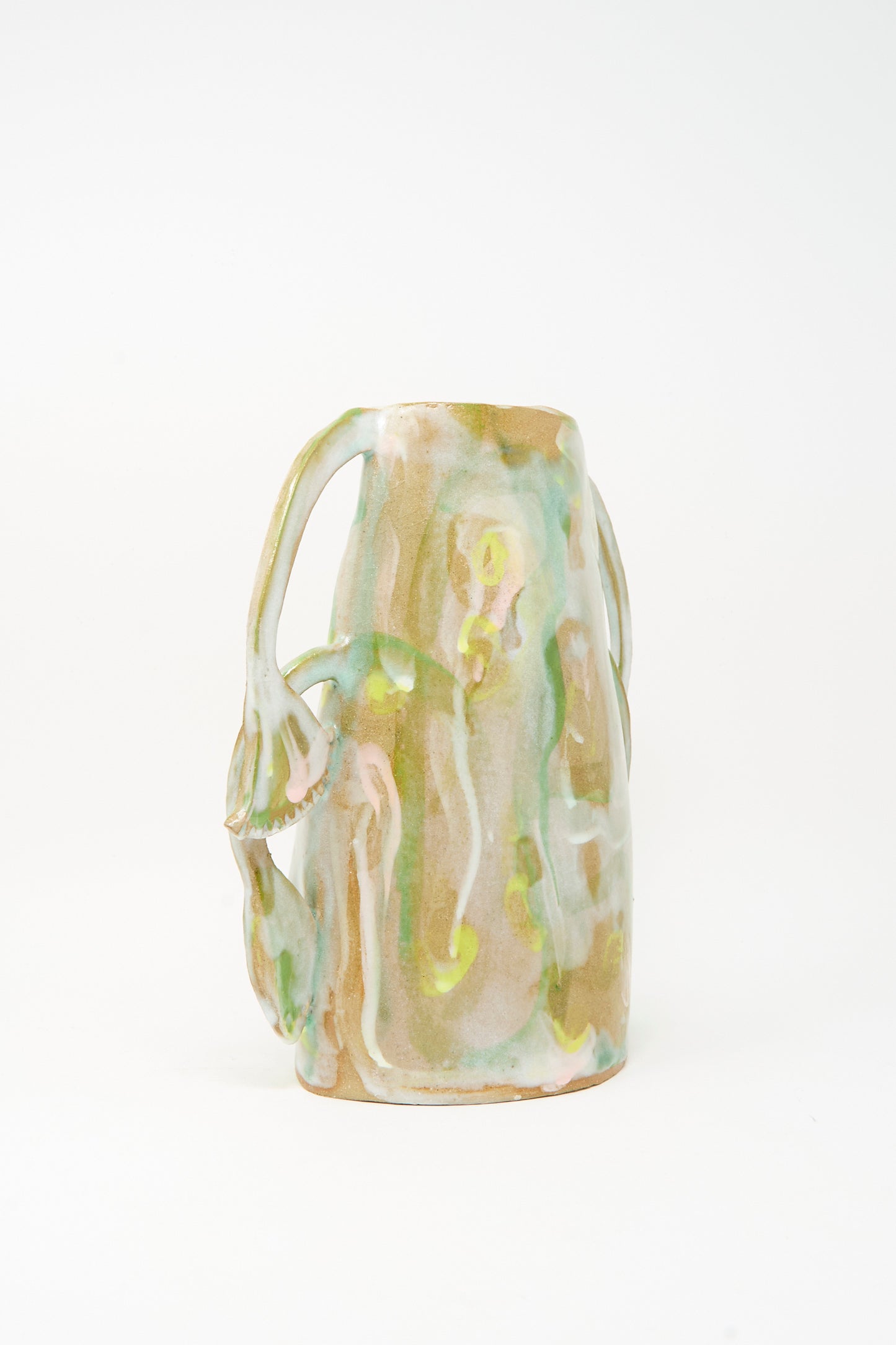 Introducing the Papyrus Bloom Vase by Tamar Mogendorff: a beige ceramic piece adorned with green and yellow abstract patterns and organic, sculpted floral handles. Handmade in Brooklyn, this unique vase showcases a harmonious blend of artistry and craftsmanship against a plain white background.