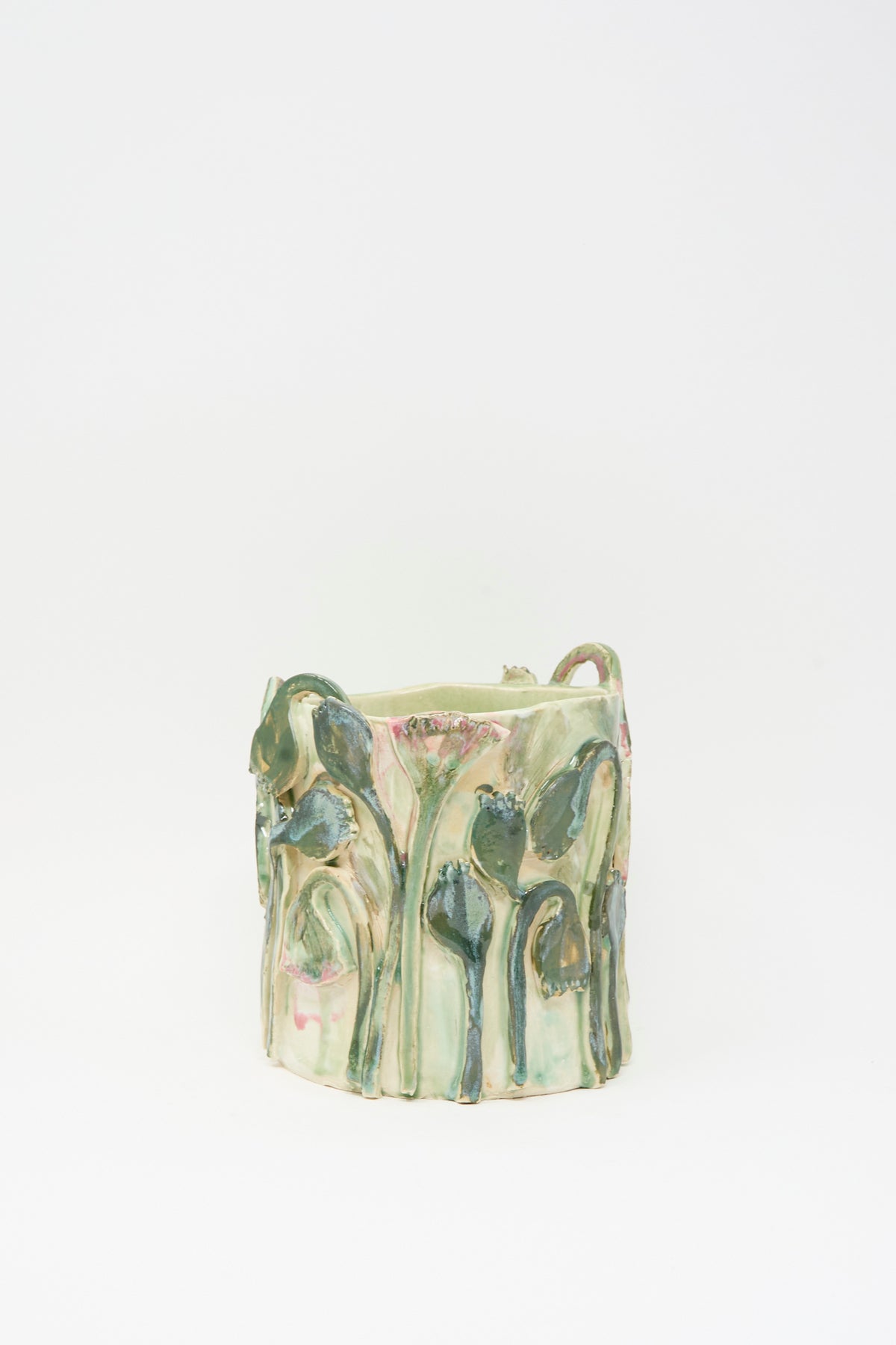 Tamar Mogendorff Papyrus Flowers Vase in Green: a pale green handmade ceramic vase decorated with raised, relief-style sculpted flowers and stems.