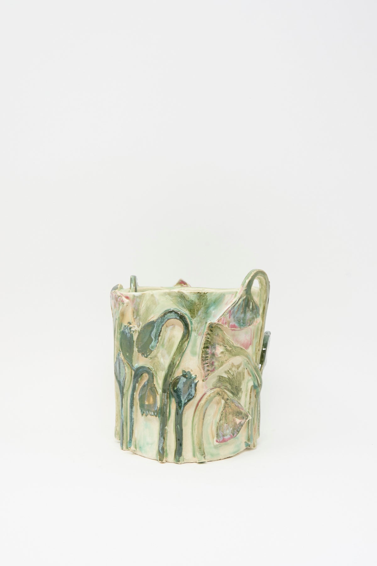 Papyrus Flowers Vase in Green: a cylindrical handmade ceramic vase with a pale green glaze featuring embossed, hand-sculpted botanical motifs.