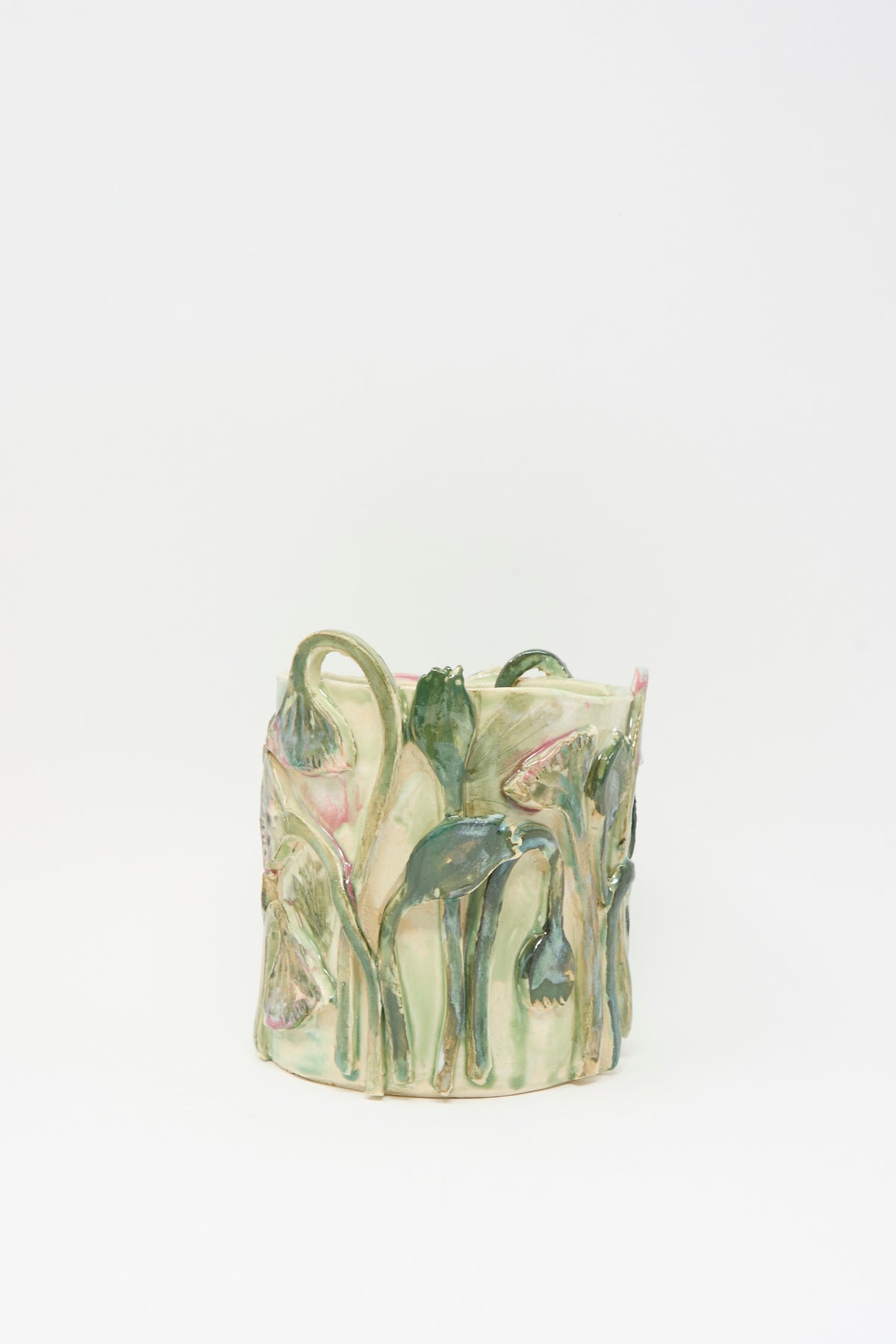 Tamar Mogendorff Papyrus Flowers Vase in Green, a cylindrical handmade ceramic vase in pale green featuring relief sculptures of drooping flowers and stems.