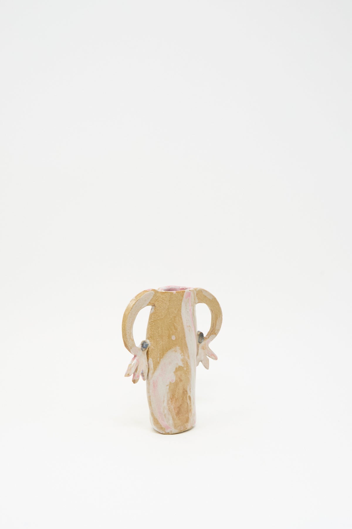 Tamar Mogendorff Pink Cyclamens Vase: a small handmade ceramic vase with two handles, multicolored pink and tan glaze swirls, and petal-like accents at the base of the handles.