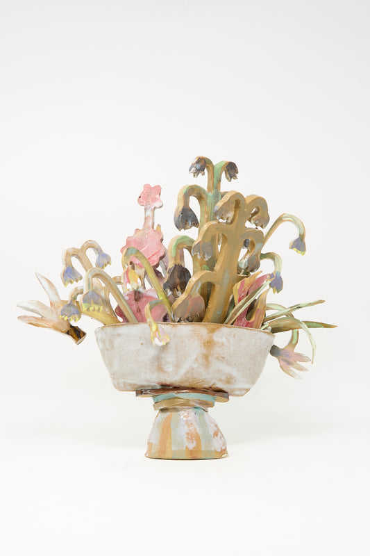 Spring Flower Arrangement by Tamar Mogendorff—a ceramic bowl perched on a pedestal, adorned with abstract flowers and stems in soft pastel hues, all set against a plain white background—captures the spirit of modern artistry and is a striking example of ceramic floral decor.