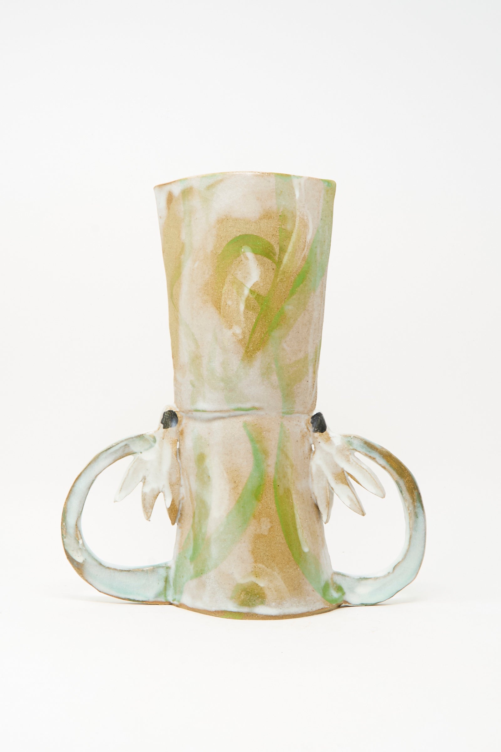 Introducing the Two Cyclamens by the Lake Vase by Tamar Mogendorff—a handmade ceramic piece inspired by Brooklyn’s creative spirit, showcasing abstract green and beige patterns and two sculptural side handles reminiscent of stylized leaves or wings.