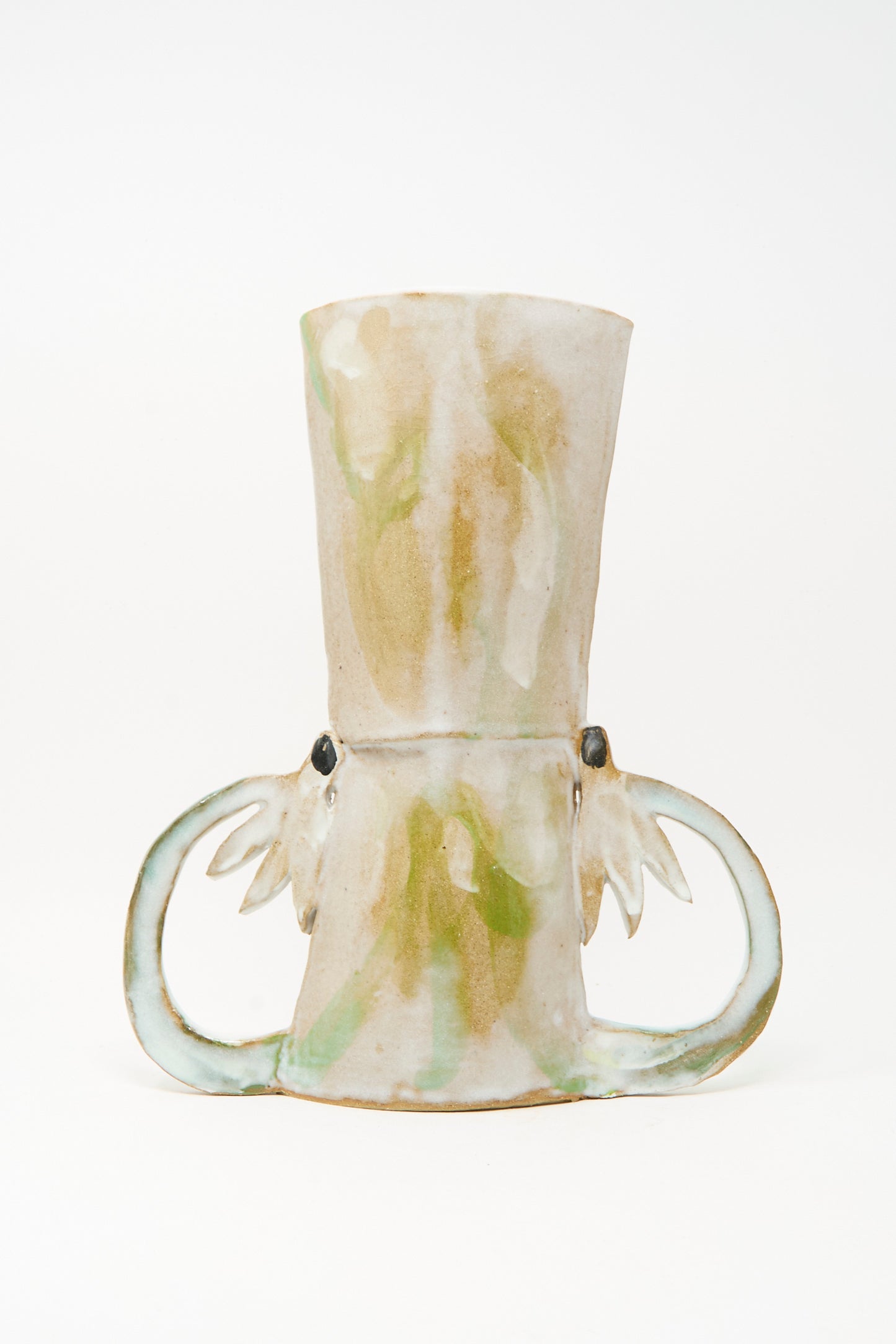 The Two Cyclamens by the Lake Vase by Tamar Mogendorff is a handmade ceramic piece from Brooklyn, showcasing a light beige and green glaze with two looped handles and subtle decorative accents near their base, displayed against a plain white background.