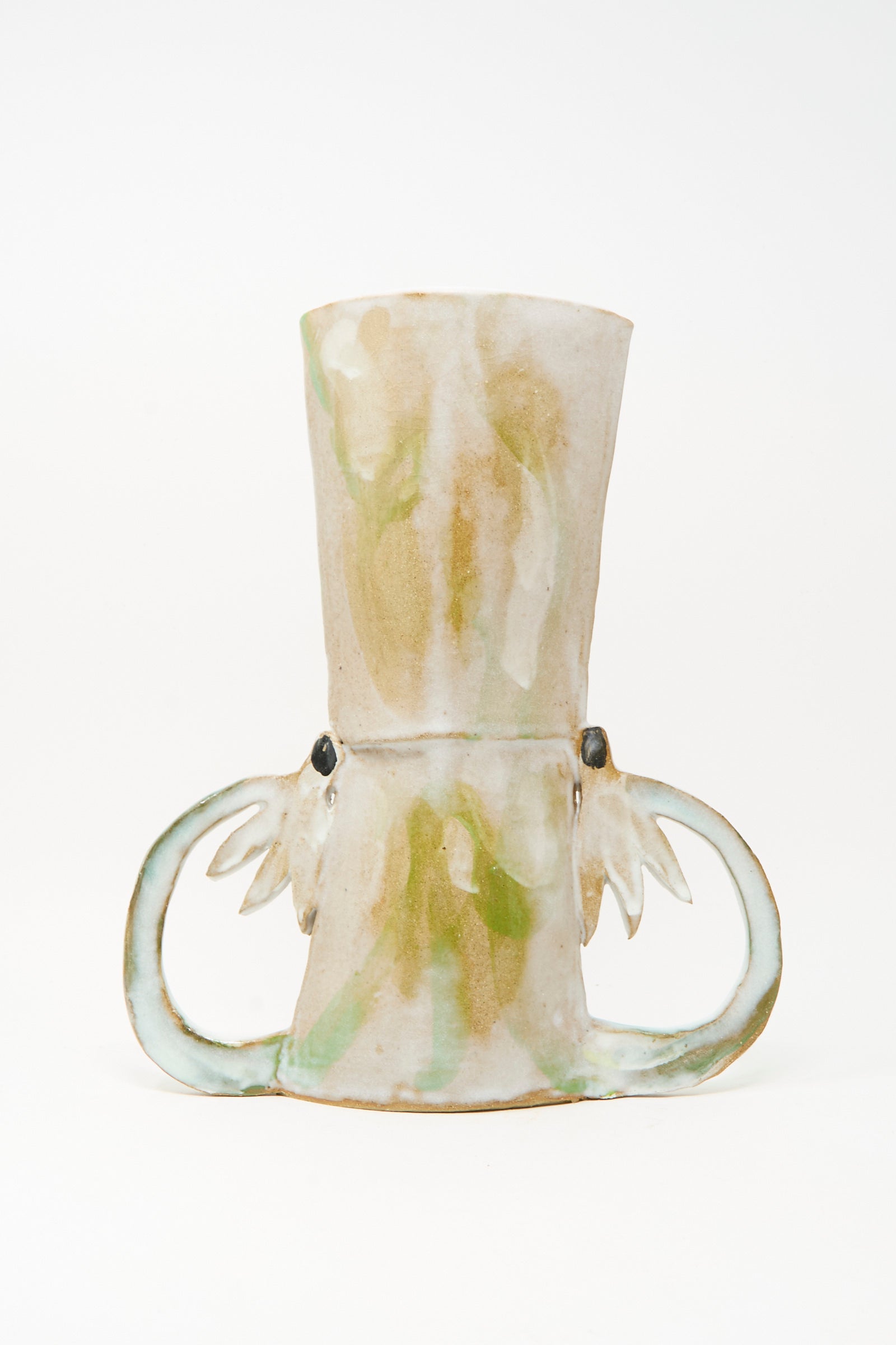 The Two Cyclamens by the Lake Vase by Tamar Mogendorff is a handmade ceramic piece from Brooklyn, showcasing a light beige and green glaze with two looped handles and subtle decorative accents near their base, displayed against a plain white background.