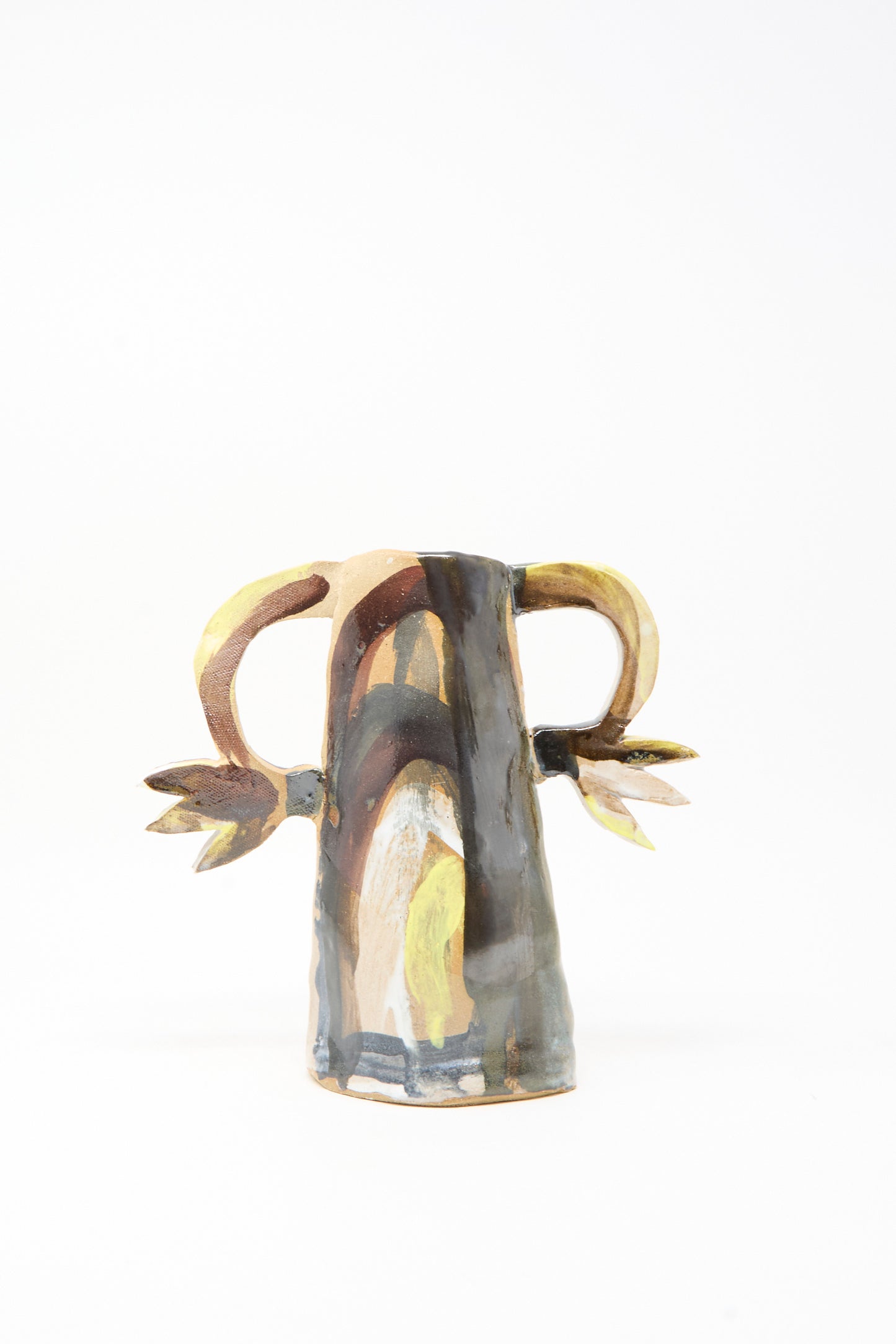 The Tamar Mogendorff "Two Cyclamens on Top of a Mountain Vase" is a handmade ceramic piece featuring horn-like handles and abstract patterns in yellow, brown, and gray on white—perfect for adding Brooklyn artistry to your space.