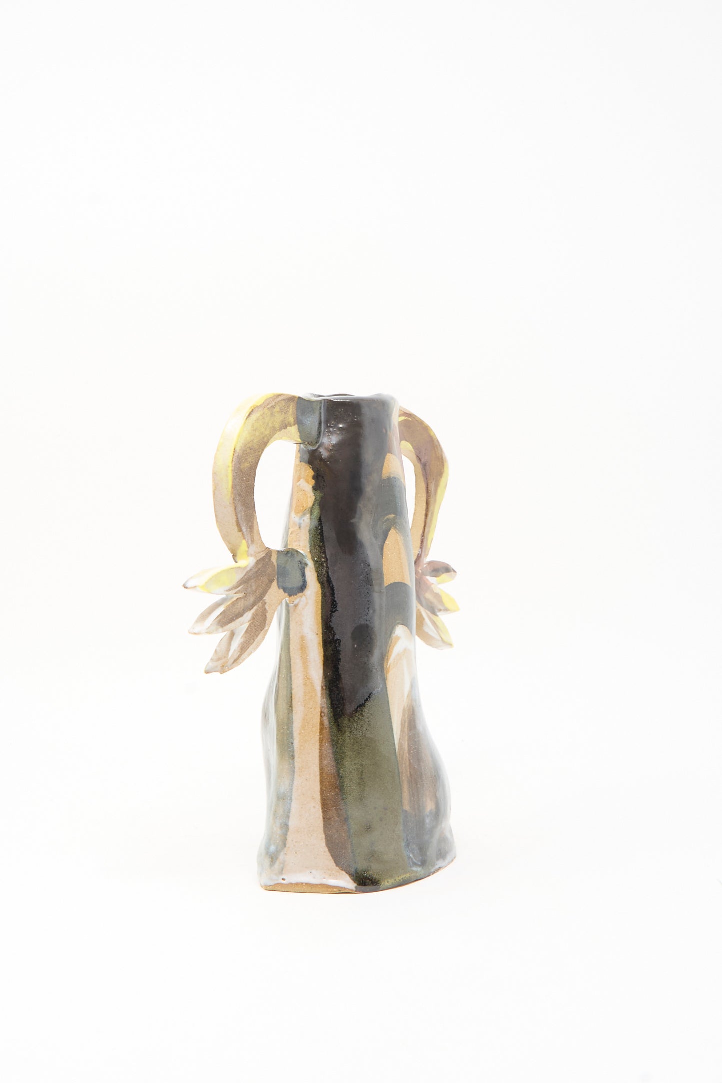 The Two Cyclamens on Top of a Mountain Vase by Tamar Mogendorff is a handmade ceramic piece with an abstract shape, earth-toned glaze, and two curved, flower-detailed handles—crafted in Brooklyn for unique style.